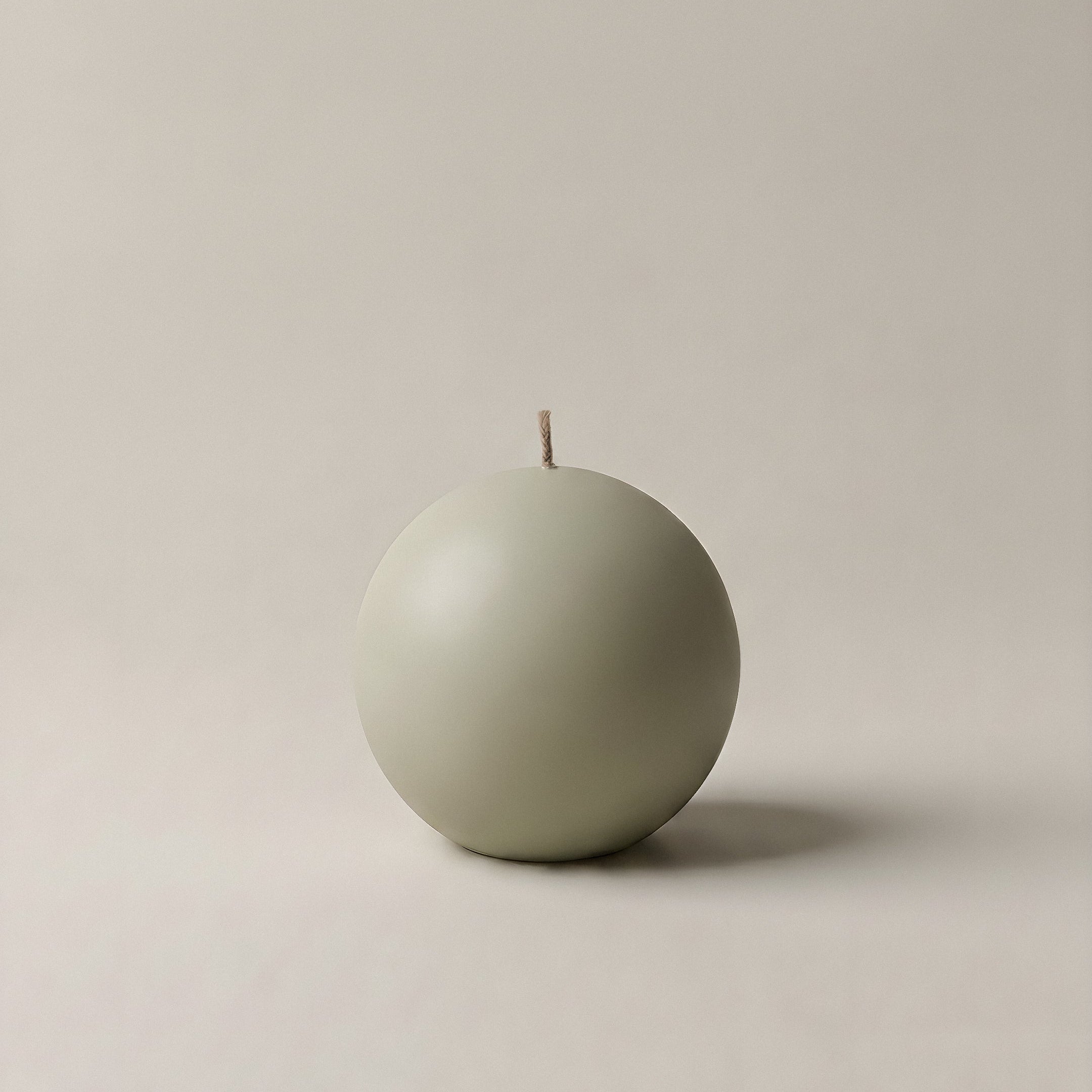 Close-up detail of handmade sphere candle showing smooth soy wax texture and cotton wick in Los Angeles studio