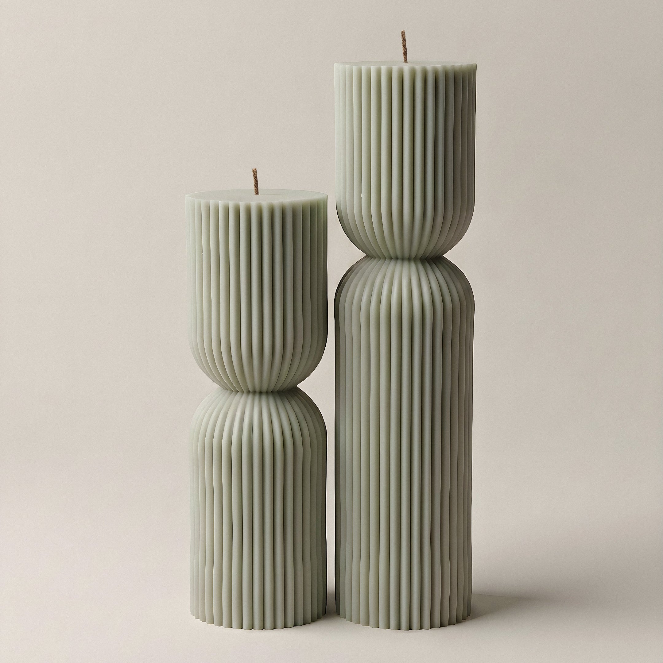 Close-up detail of handmade hourglass sculptural candle showing smooth soy wax texture and natural cotton wick