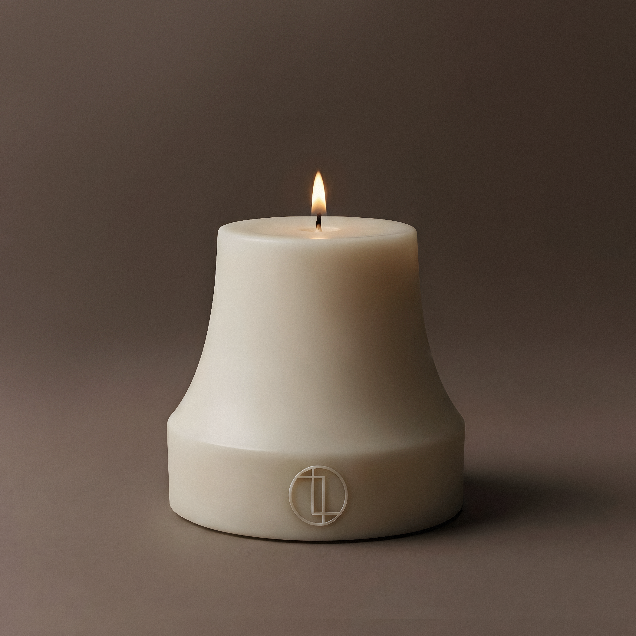 White Bell candle with a lit wick on a dark brown background
