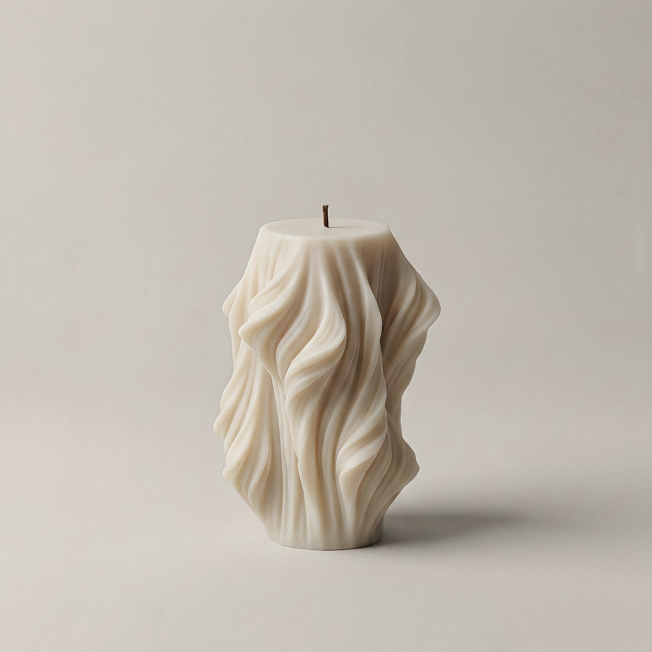 White sculptural candle with cascading wave design, handmade from unscented soy wax in Los Angeles