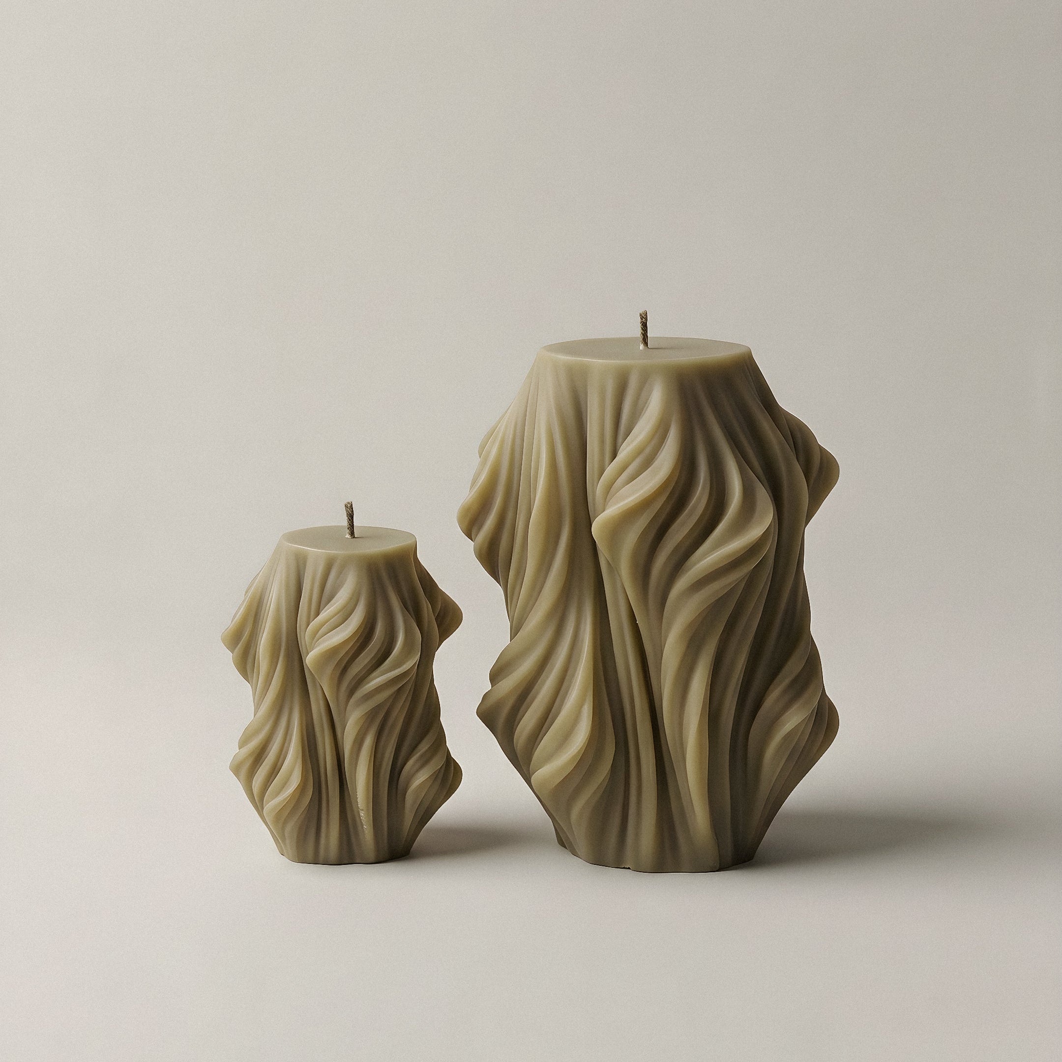 Close-up detail of handmade Cascading Wave sculptural candle showing textured soy wax layers in natural light
