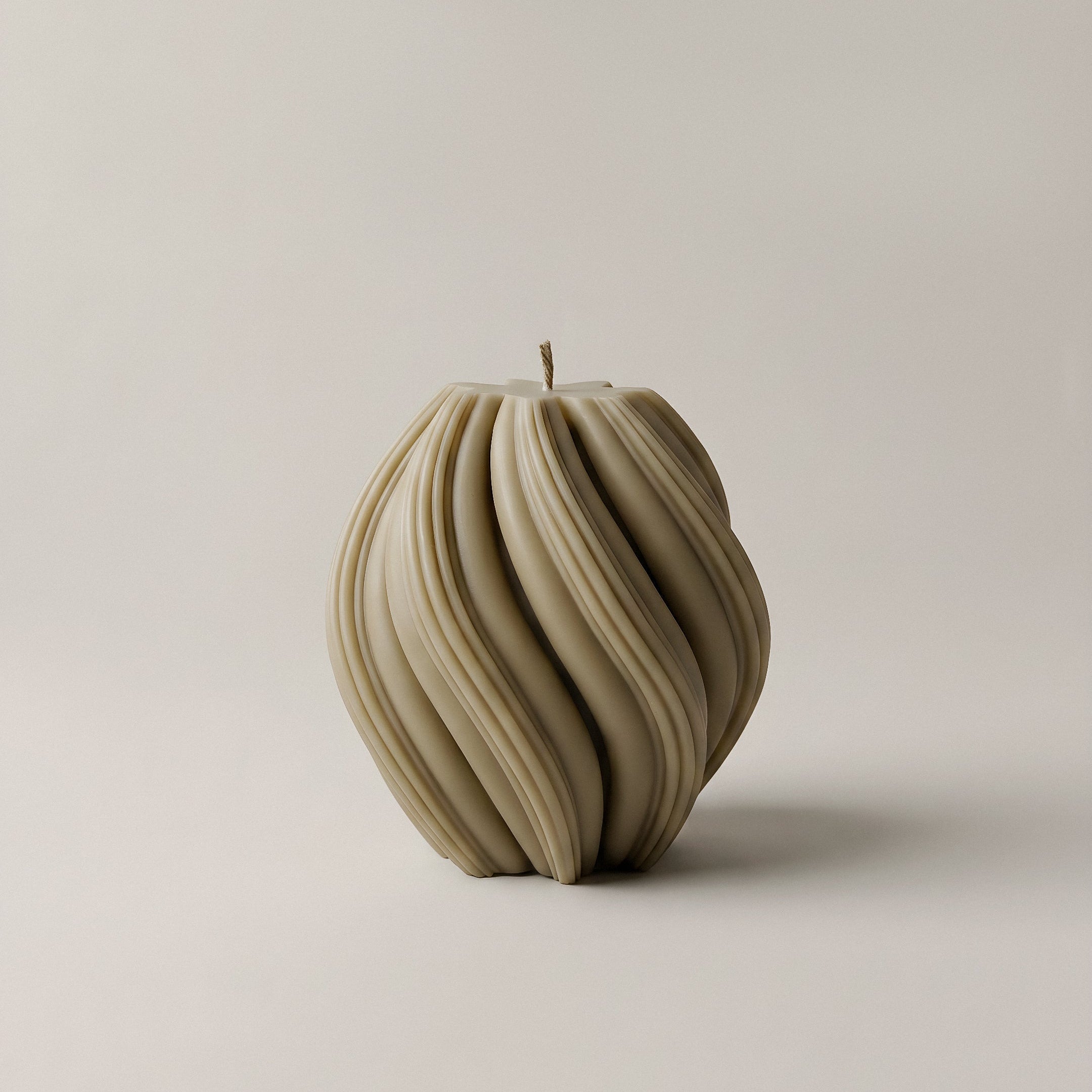 Close-up detail of handmade sculptural swirl candle showing premium soy wax texture and artisan craftsmanship
