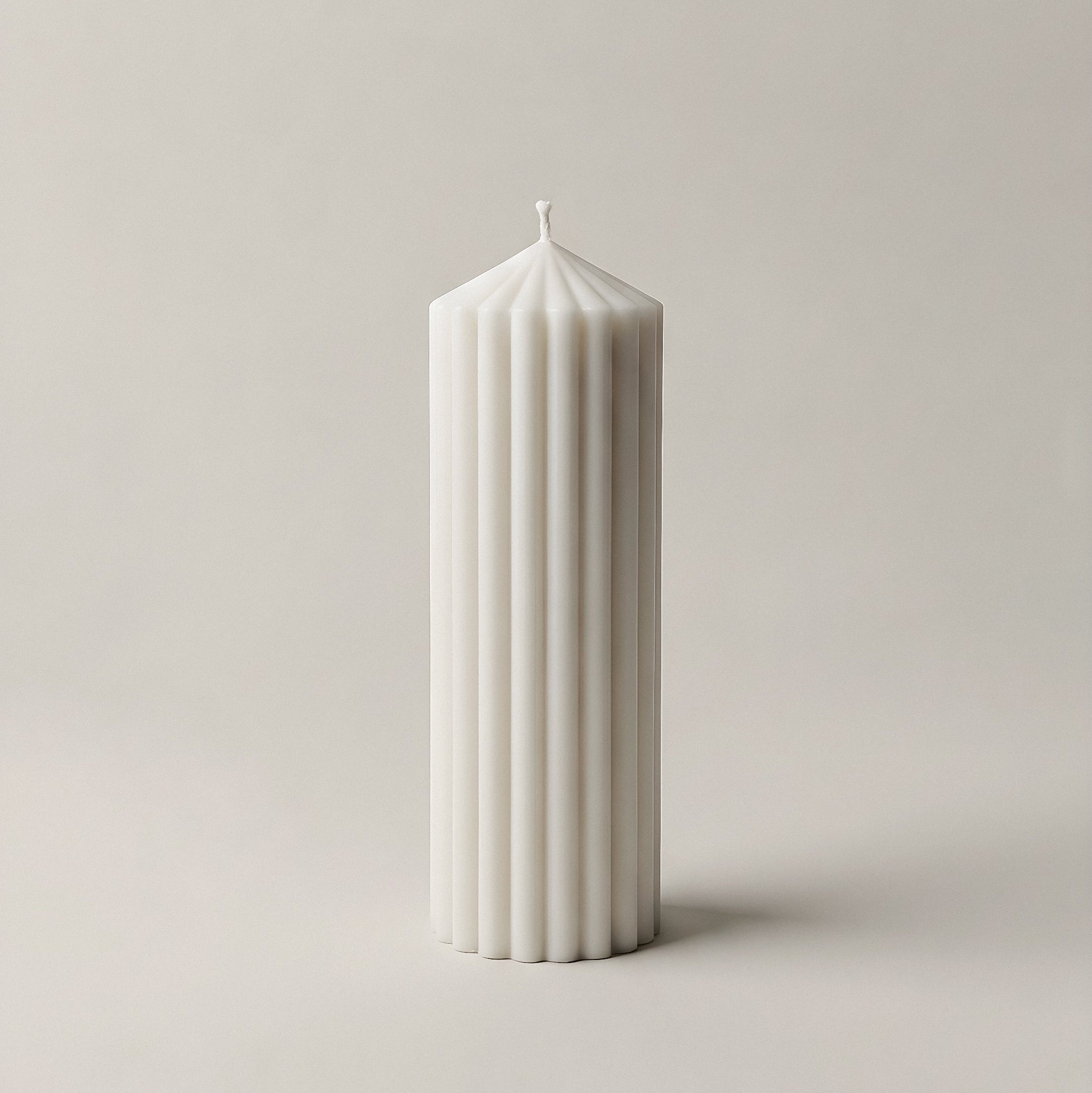 Close-up detail of handmade Peak sculptural candle showing smooth soy wax texture and natural cotton wick