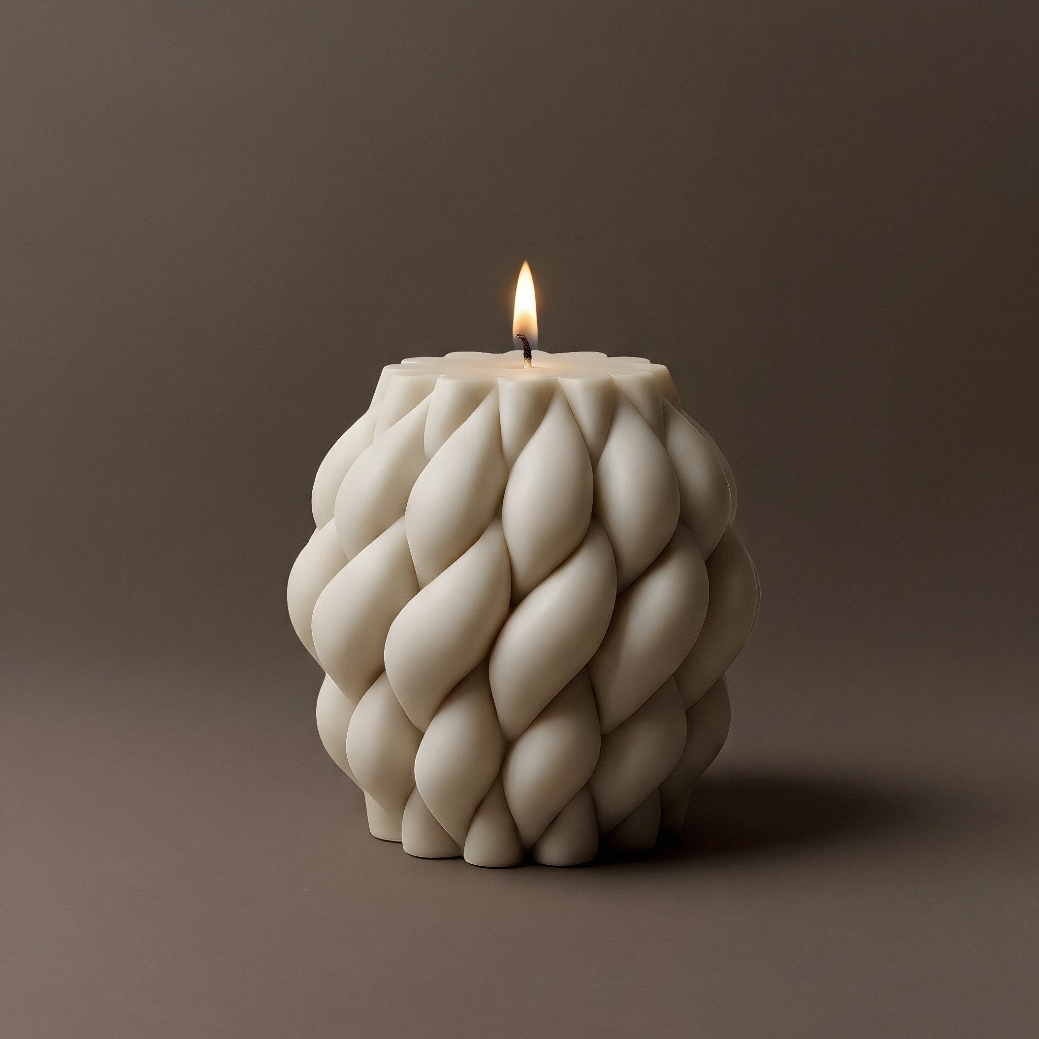 Close-up view of handmade Knot Ball sculptural candle showing soy wax texture and intricate knotted design details