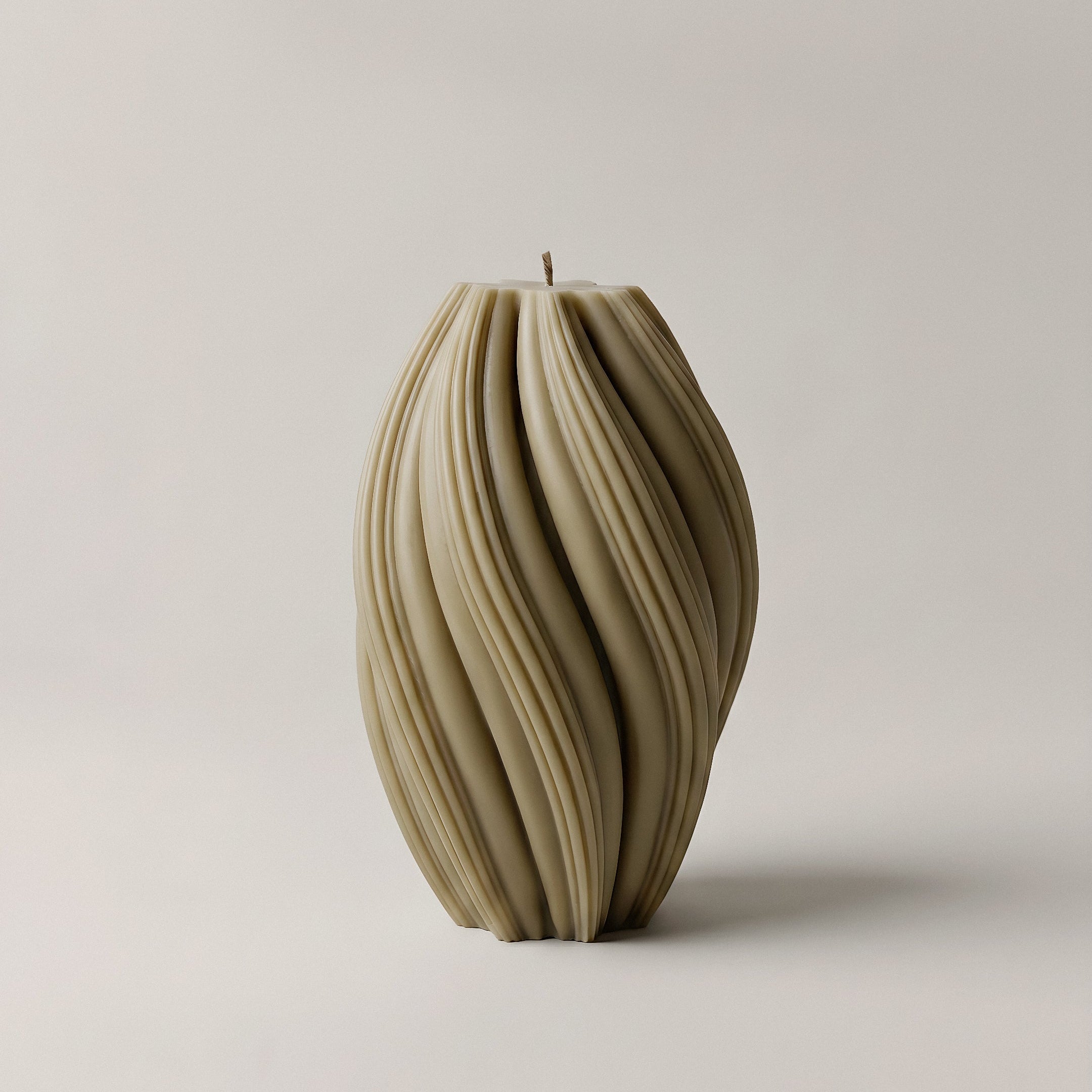 Close-up detail of handmade swirl sculptural candle showing premium soy wax texture and twisted design