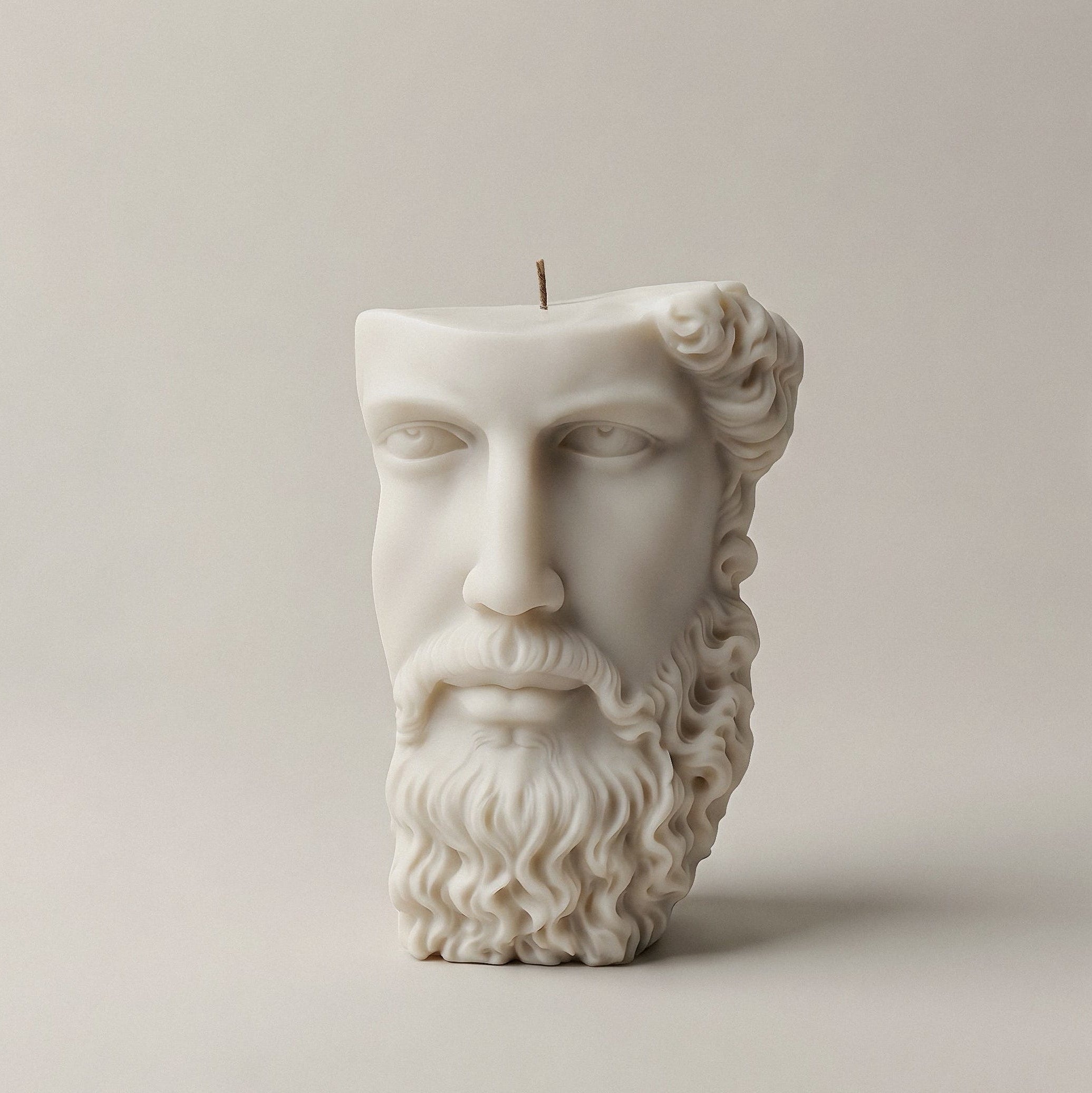 White sculptural candle shaped like a Greek face made from unscented soy wax, handmade in Los Angeles