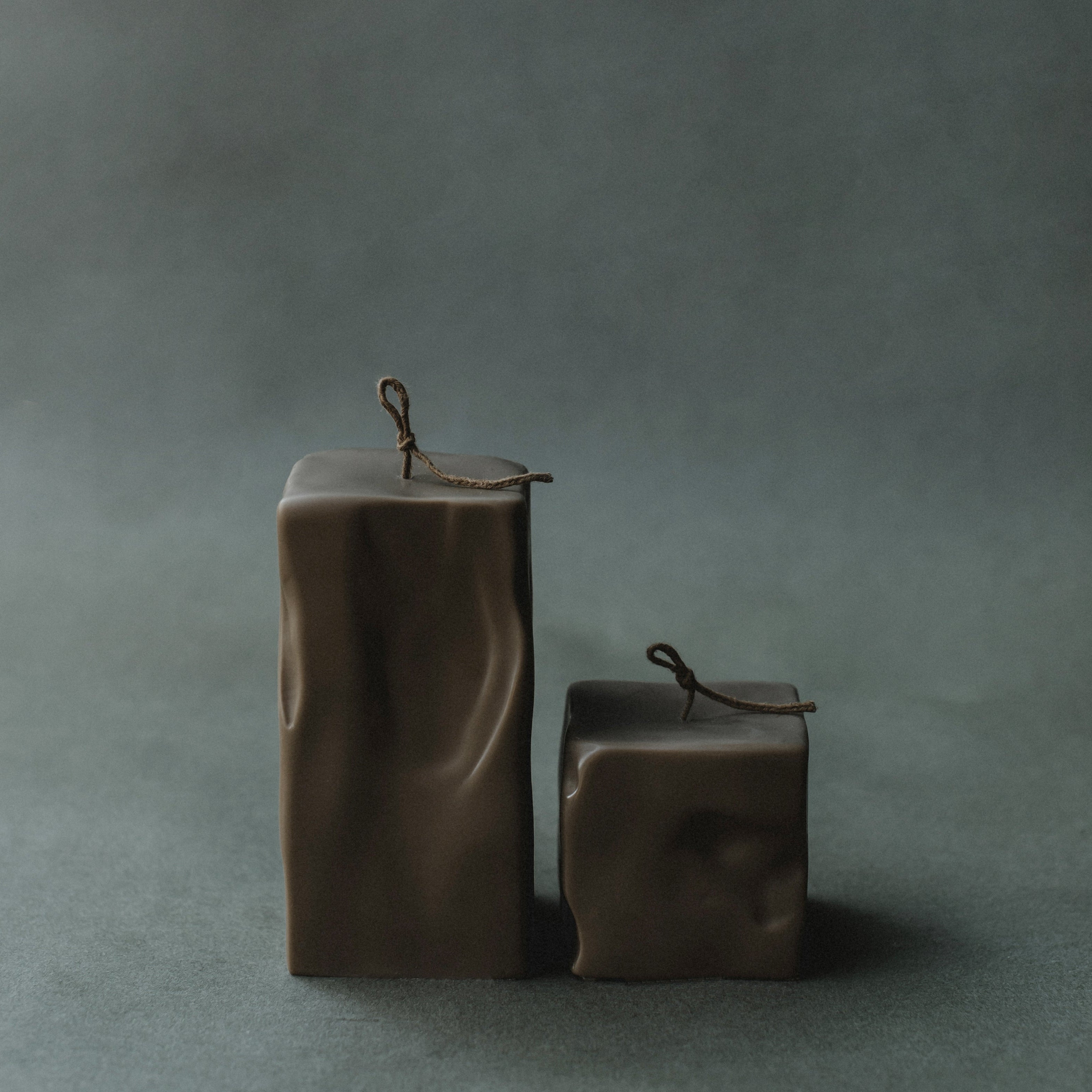 Set of two kobicha raw block candles by LAWA on a gray background