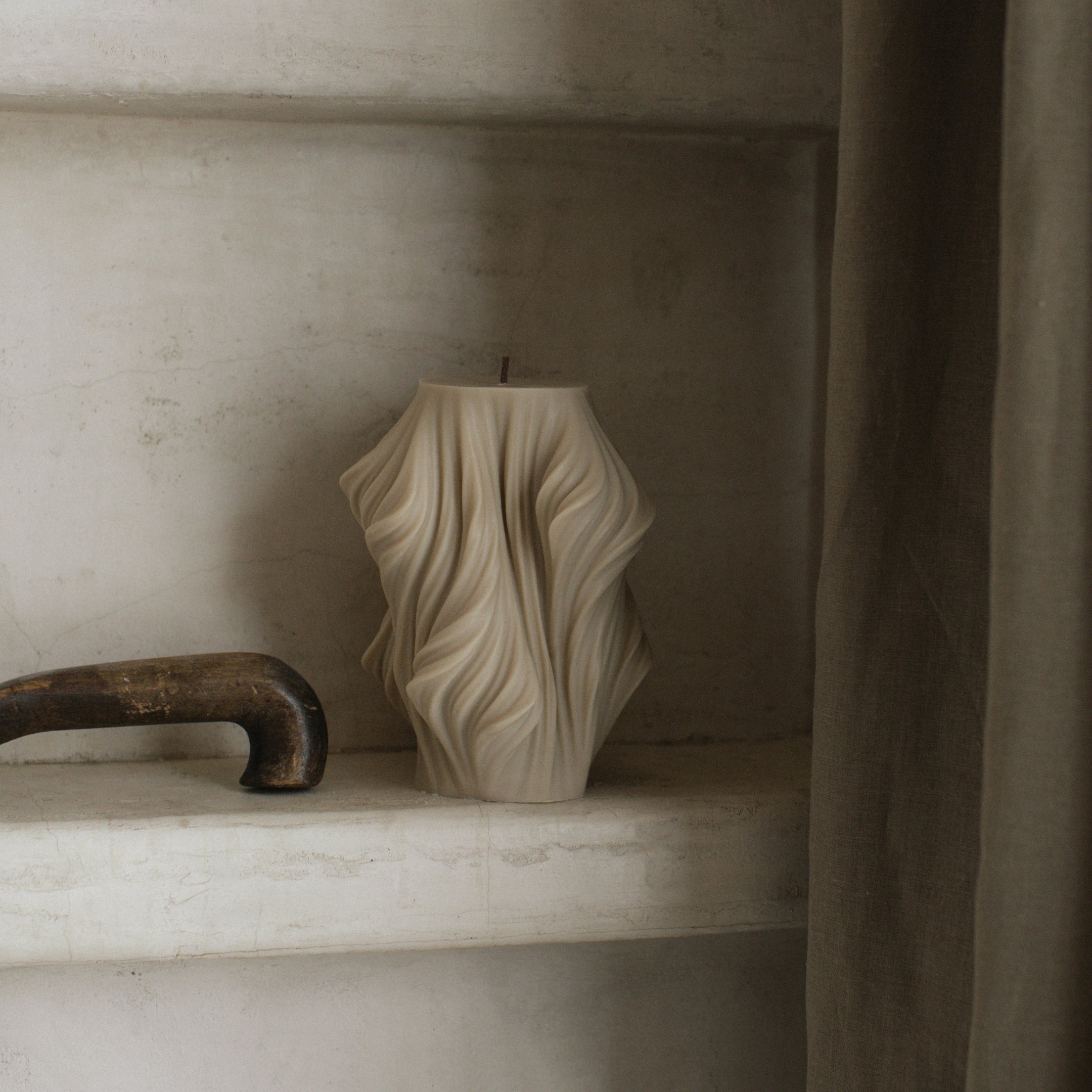 Close-up detail of handmade sculptural candle showing cascading wave texture in premium soy wax from Los Angeles