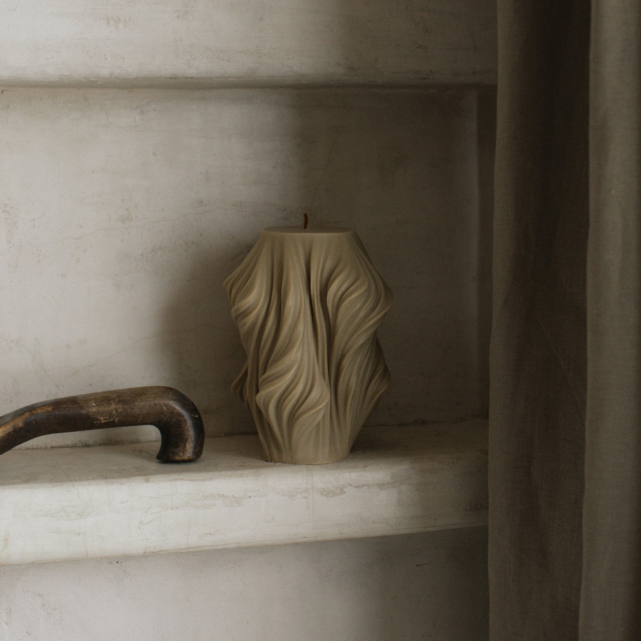 Close-up detail of handmade sculptural candle with cascading wave texture in premium soy wax from Los Angeles