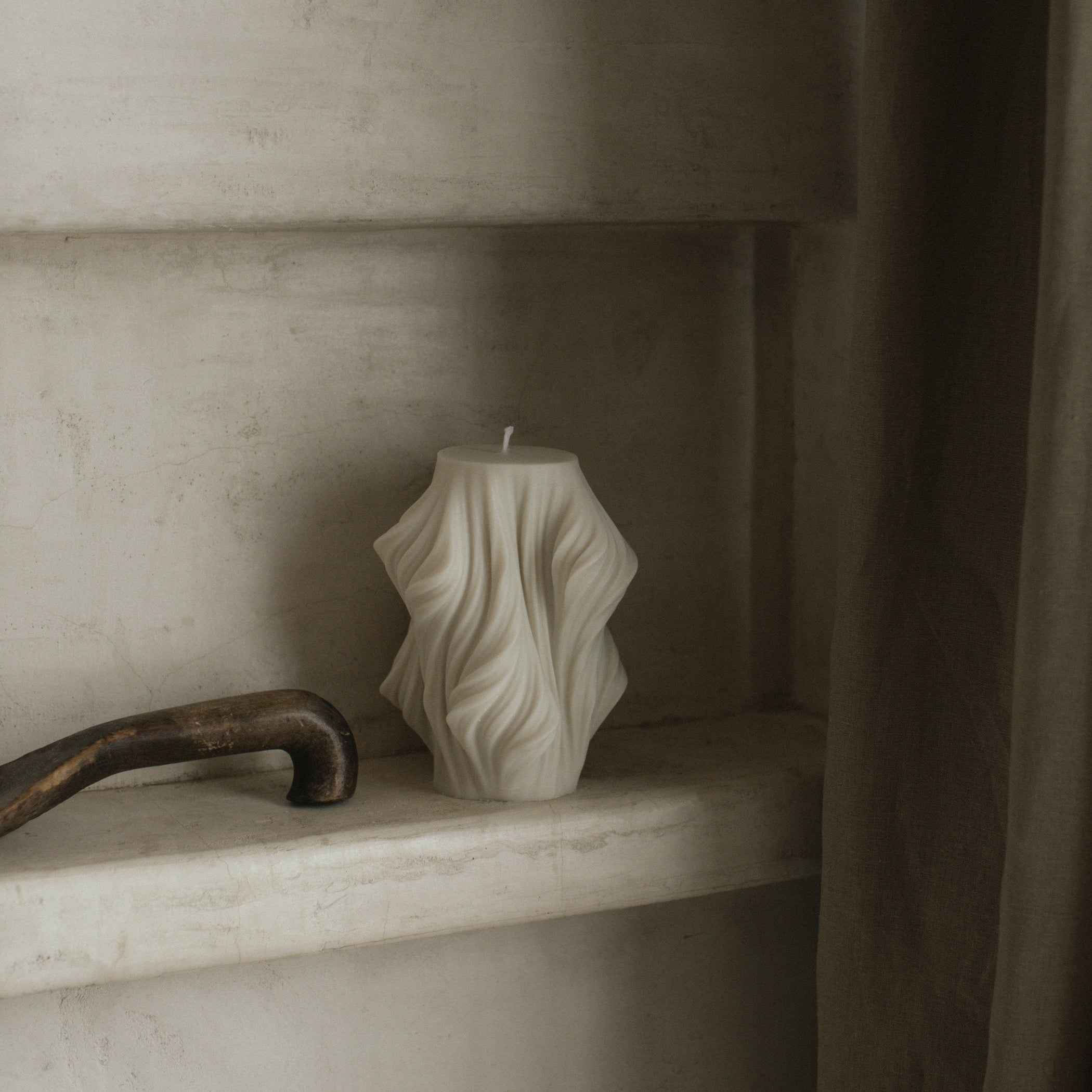 Close-up detail of handmade sculptural candle showing cascading wave texture in premium soy wax from Los Angeles