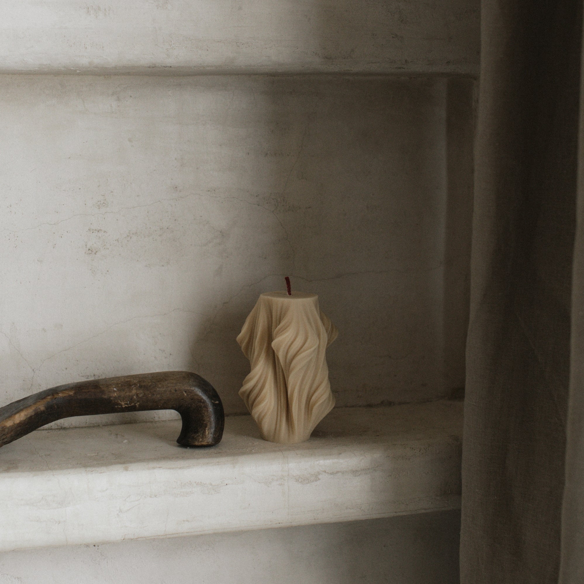 Close-up detail of handmade sculptural candle with cascading wave texture in premium soy wax from Los Angeles