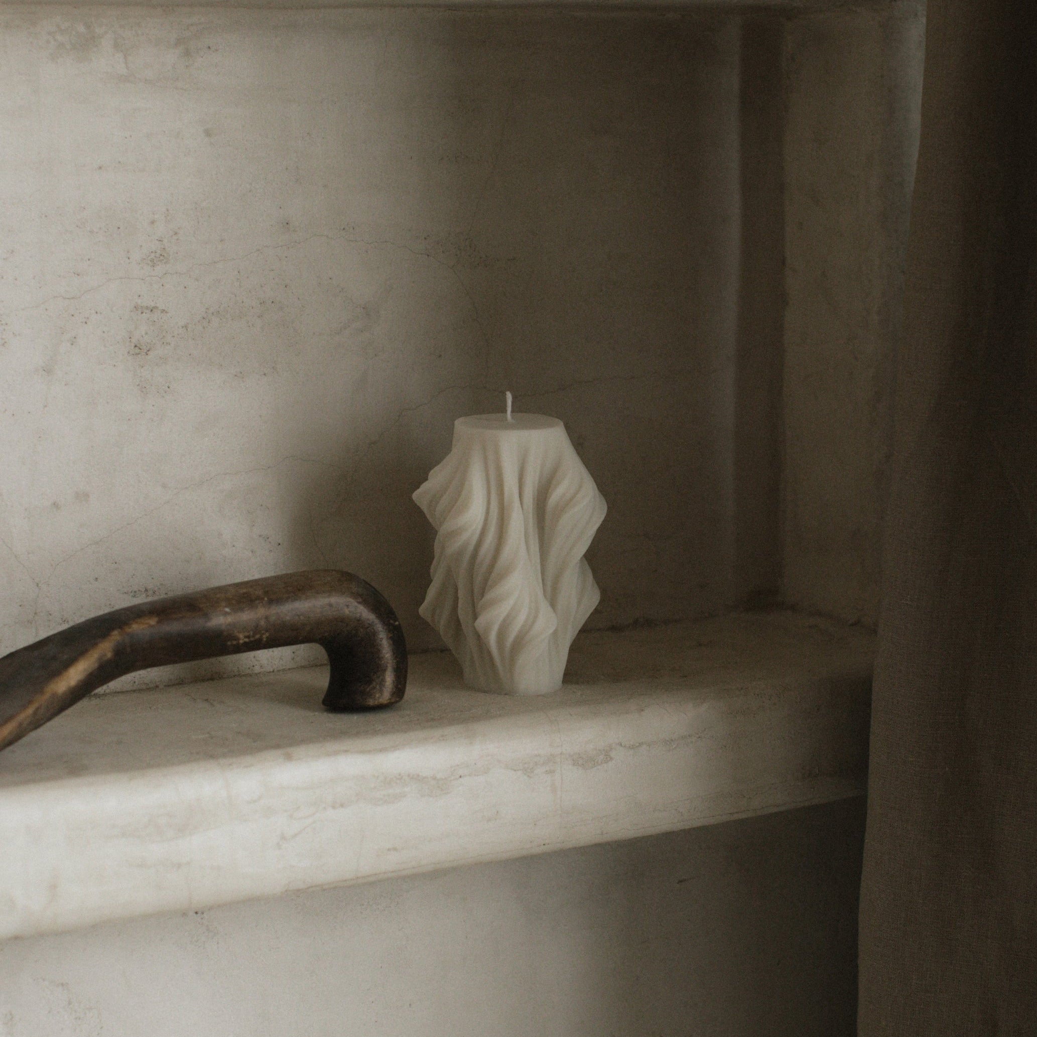Close-up detail of handmade sculptural candle showing cascading wave texture in premium soy wax from Los Angeles