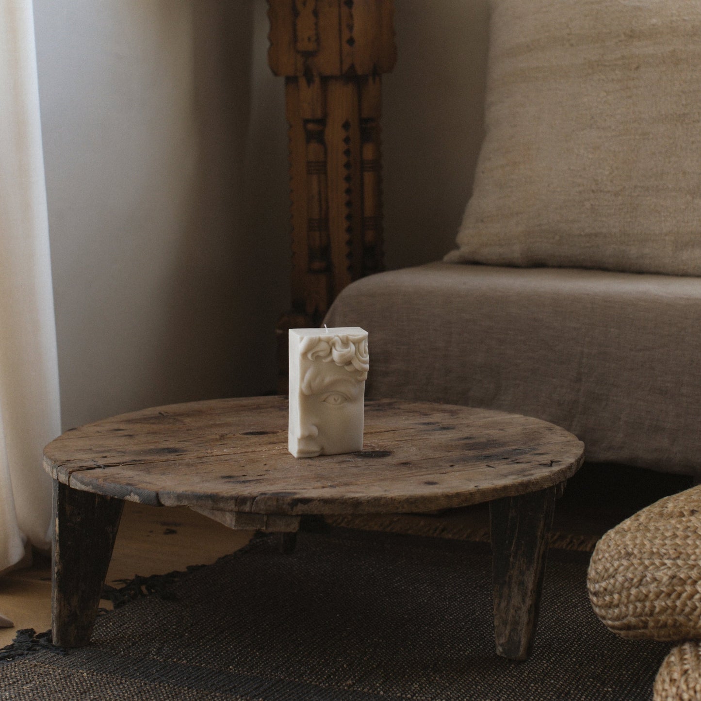 Handmade sculptural candle featuring half face design in premium soy wax close-up detail shot