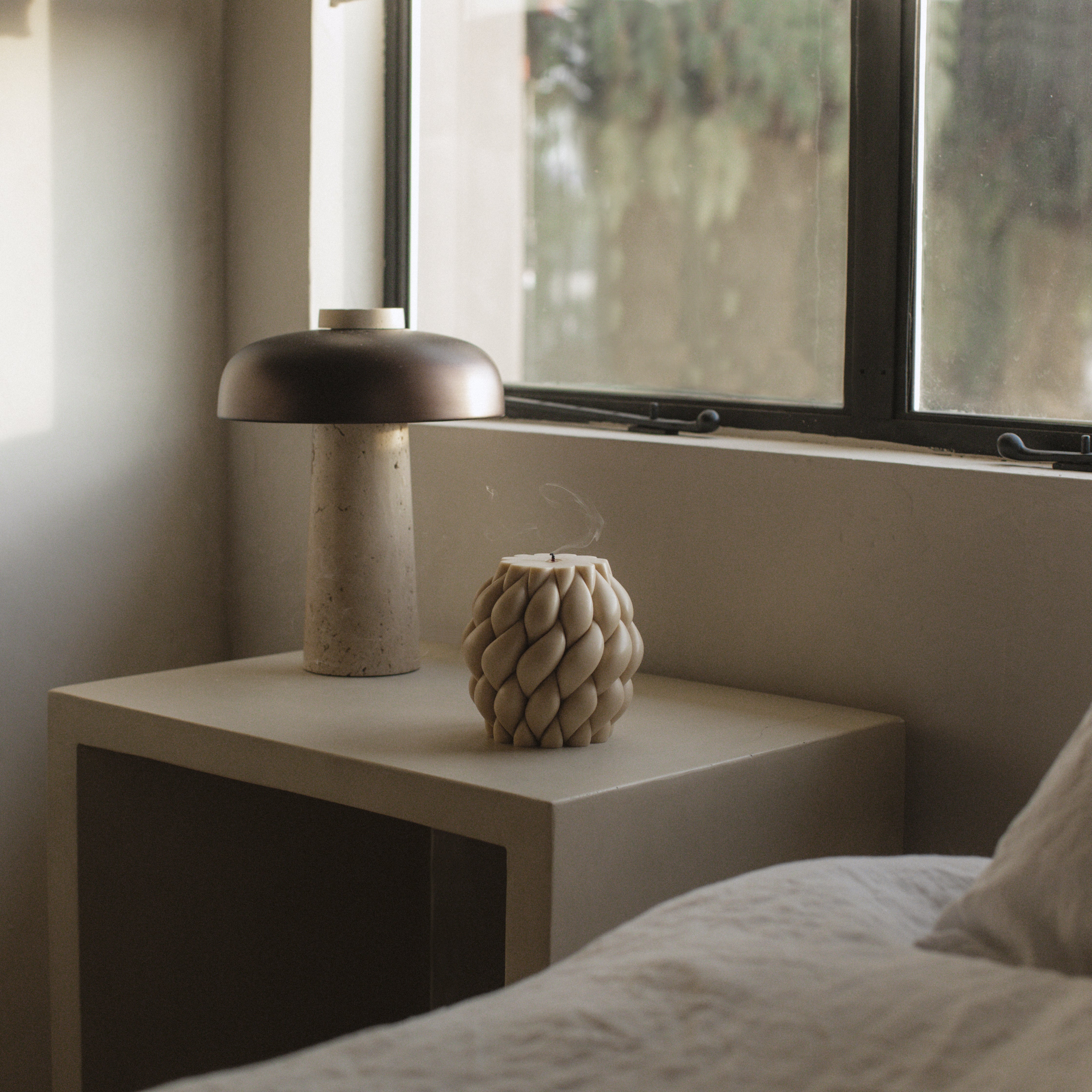 Handmade sculptural knot ball candle made from premium soy wax displayed in a styled Los Angeles home setting
