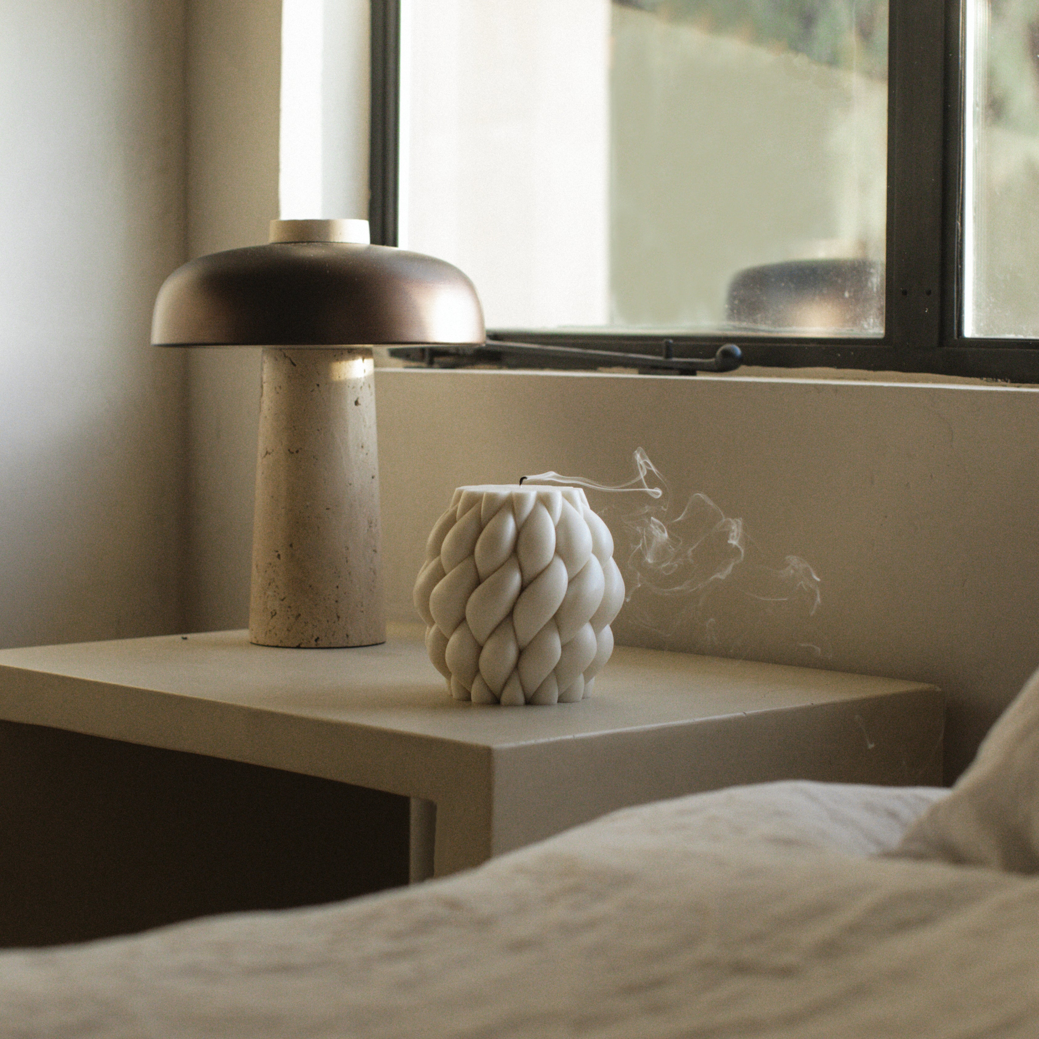 Close-up detail of handmade Knot Ball sculptural candle showing premium soy wax texture and cotton wick