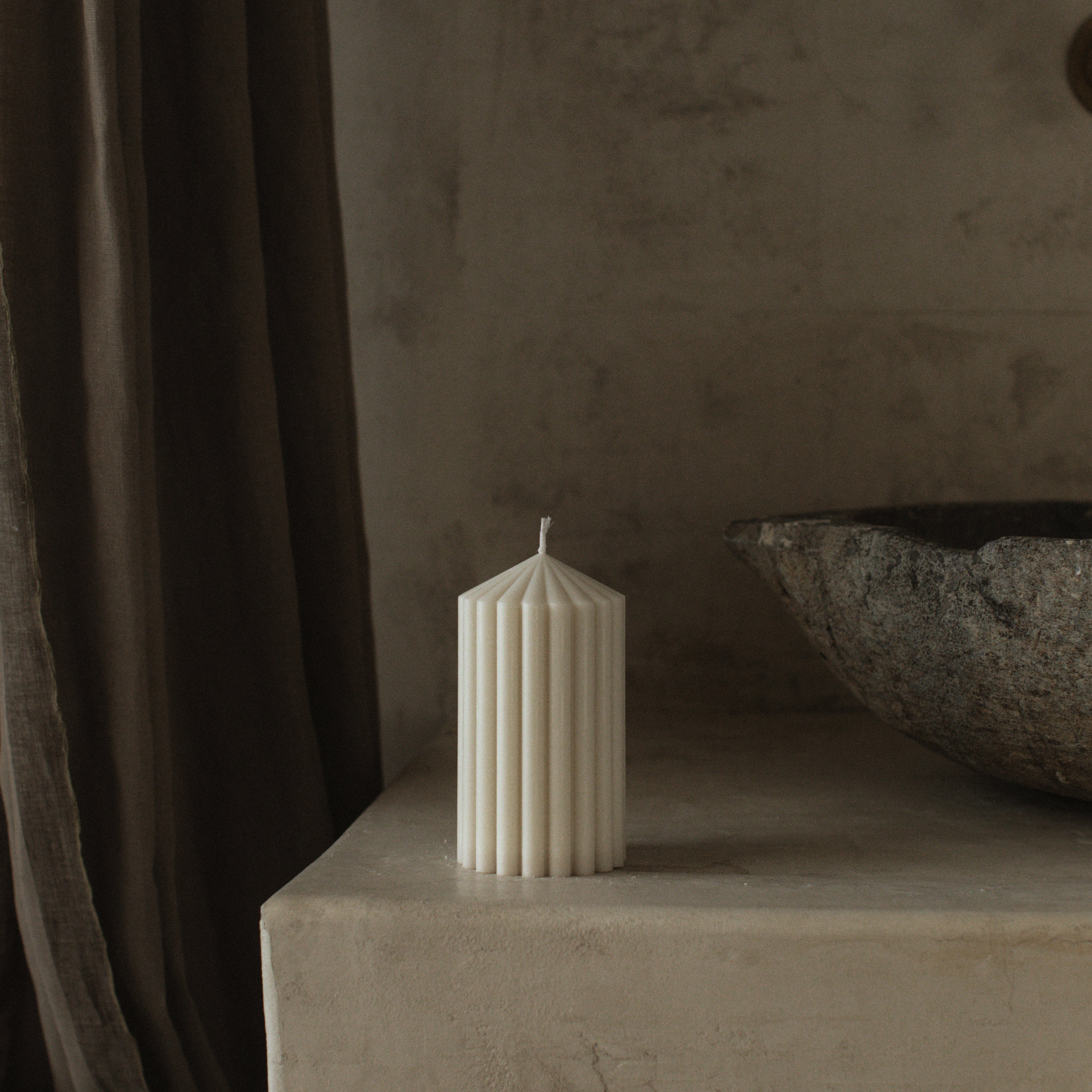 LAWA small white soy wax peak candle featuring a pointed geometric top on a stone surface with a neutral background