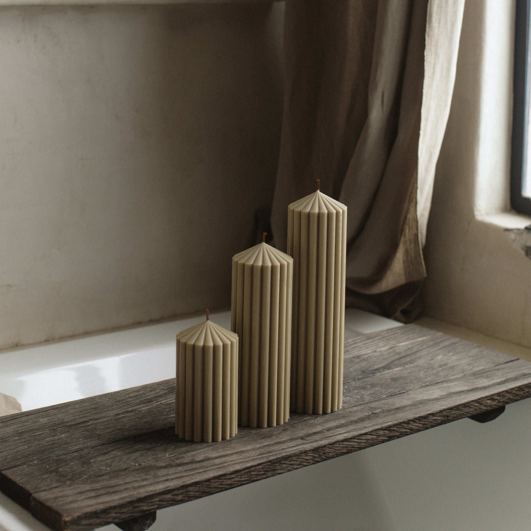 LAWA olive beige peak candle trio with sculptural mountain-inspired shapes on a wooden surface with a neutral background