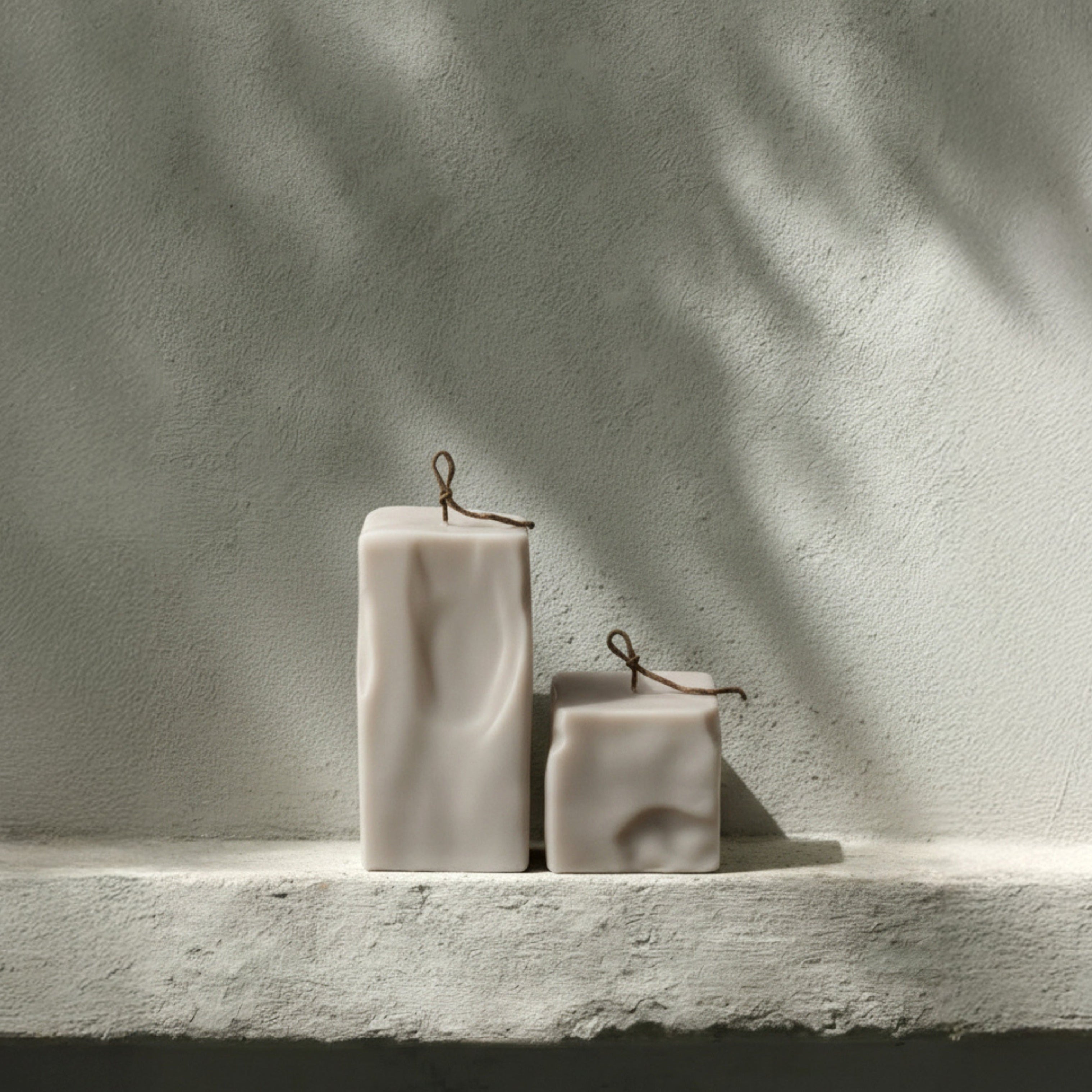 LAWA raw block set of candles in light beige on a stone surface with a neutral background