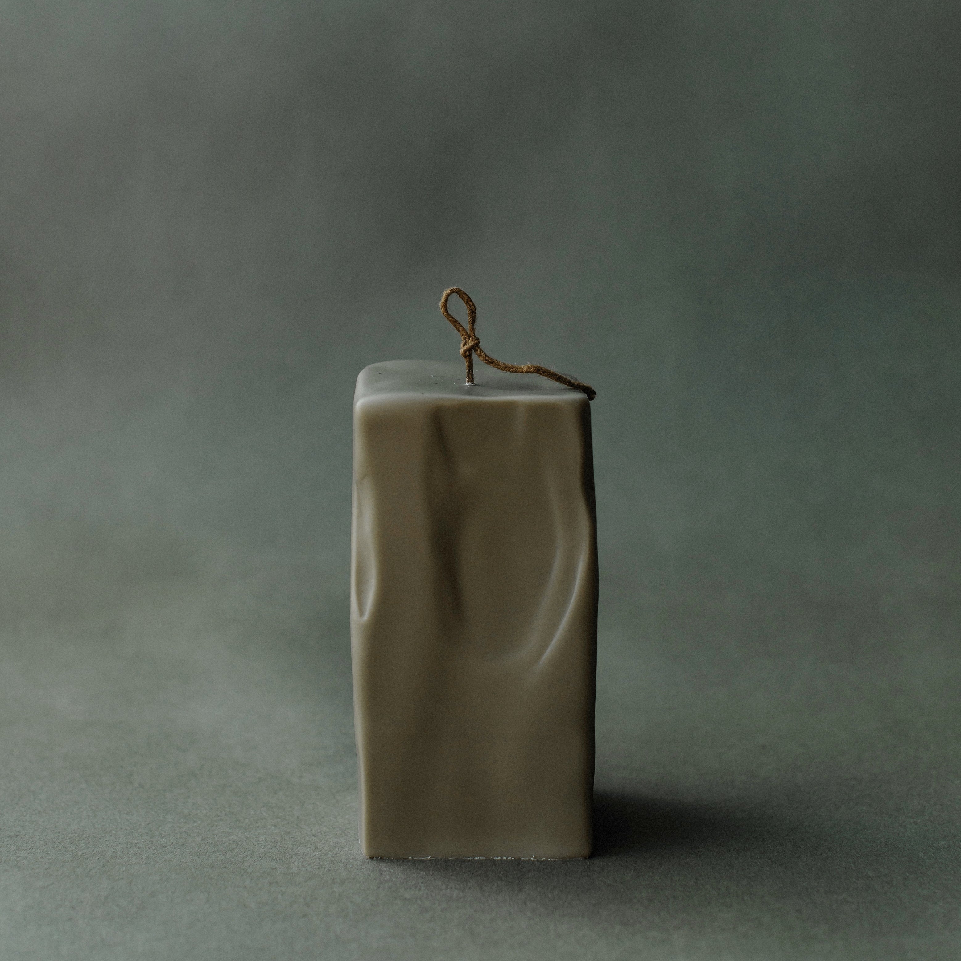Large earthy green raw block candle by LAWA with sculptural minimalist shape