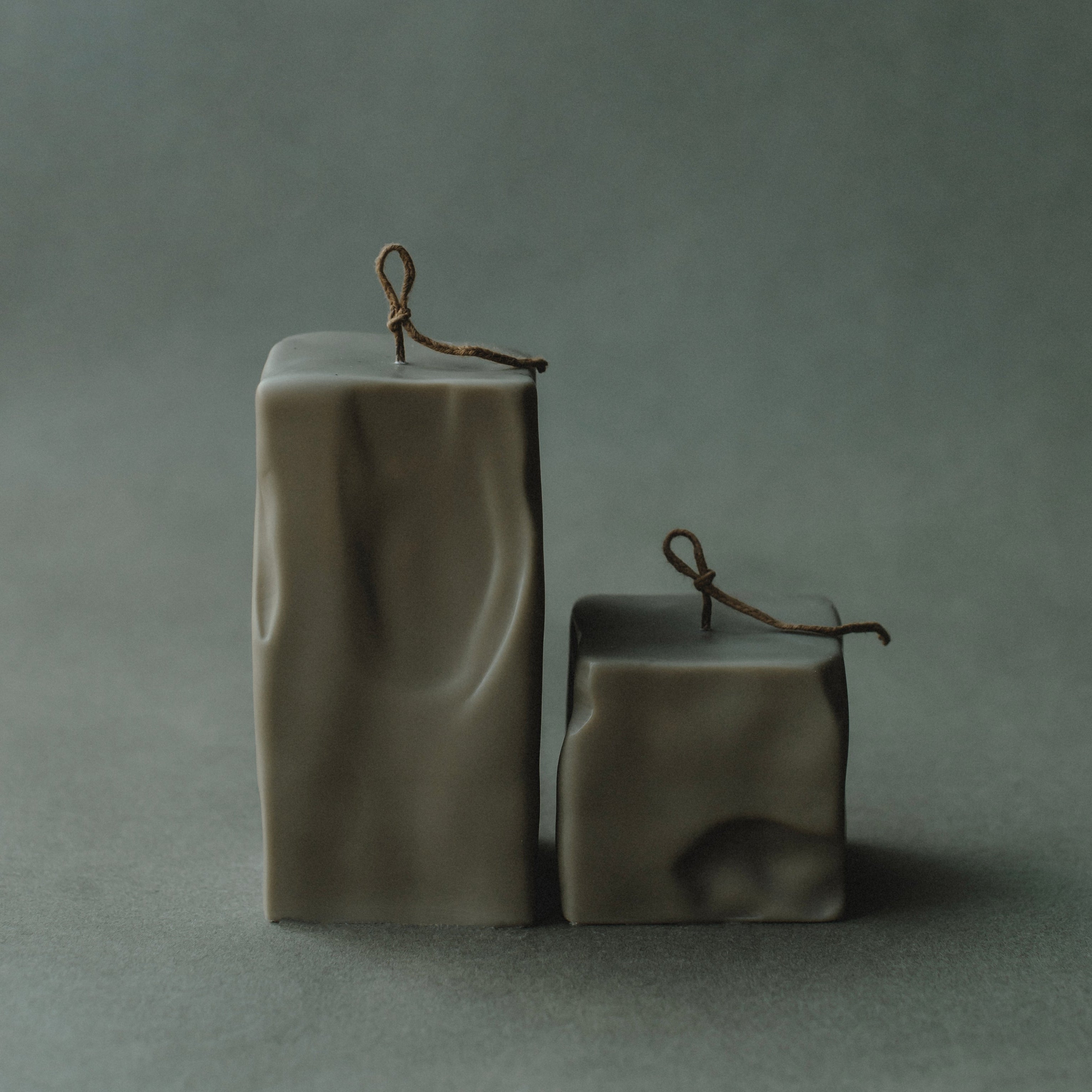 Set of two earthy green raw block candles by LAWA with sculptural minimalist form