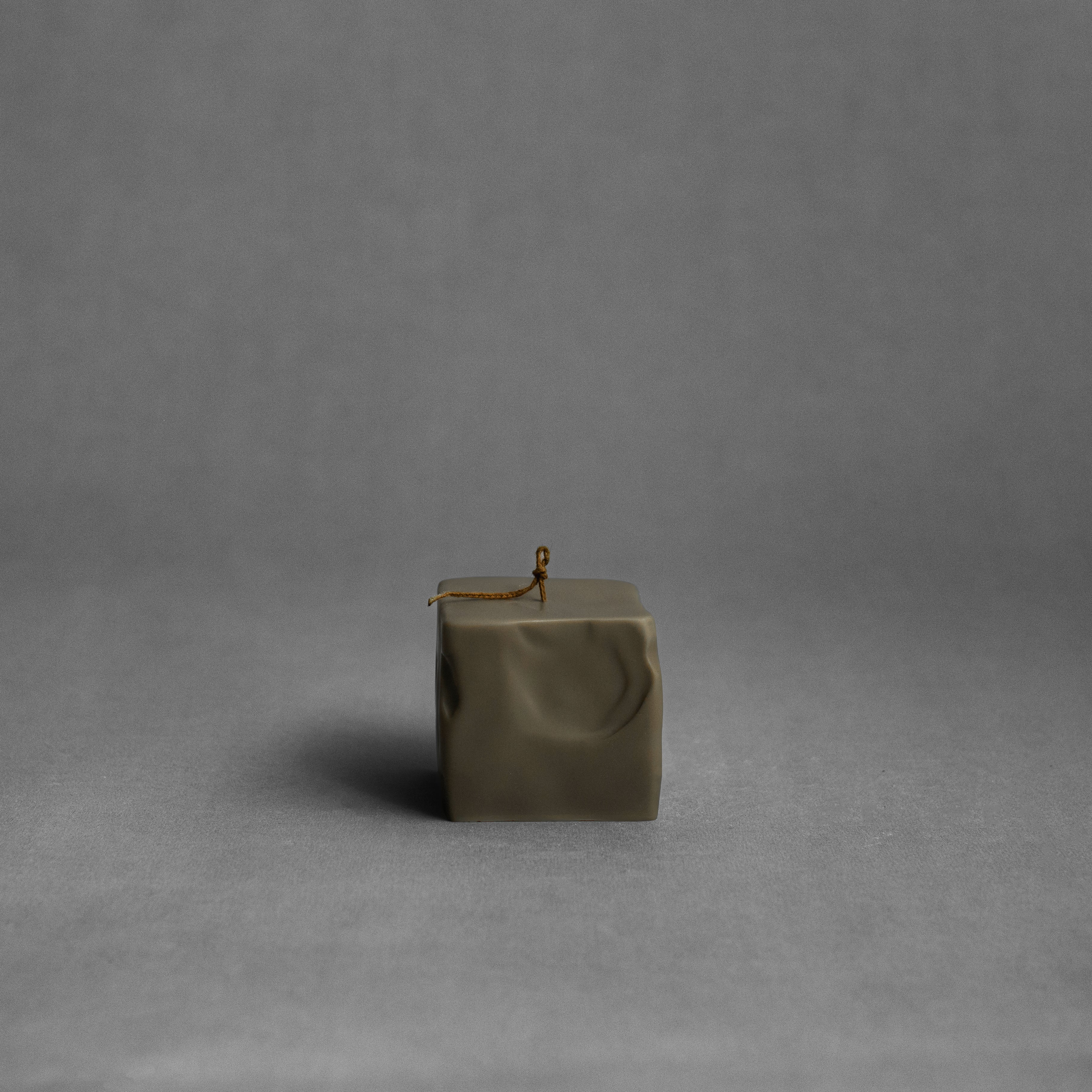 Small earthy green raw block pillar soy wax candle by LAWA with minimalist geometric shape for contemporary homes
