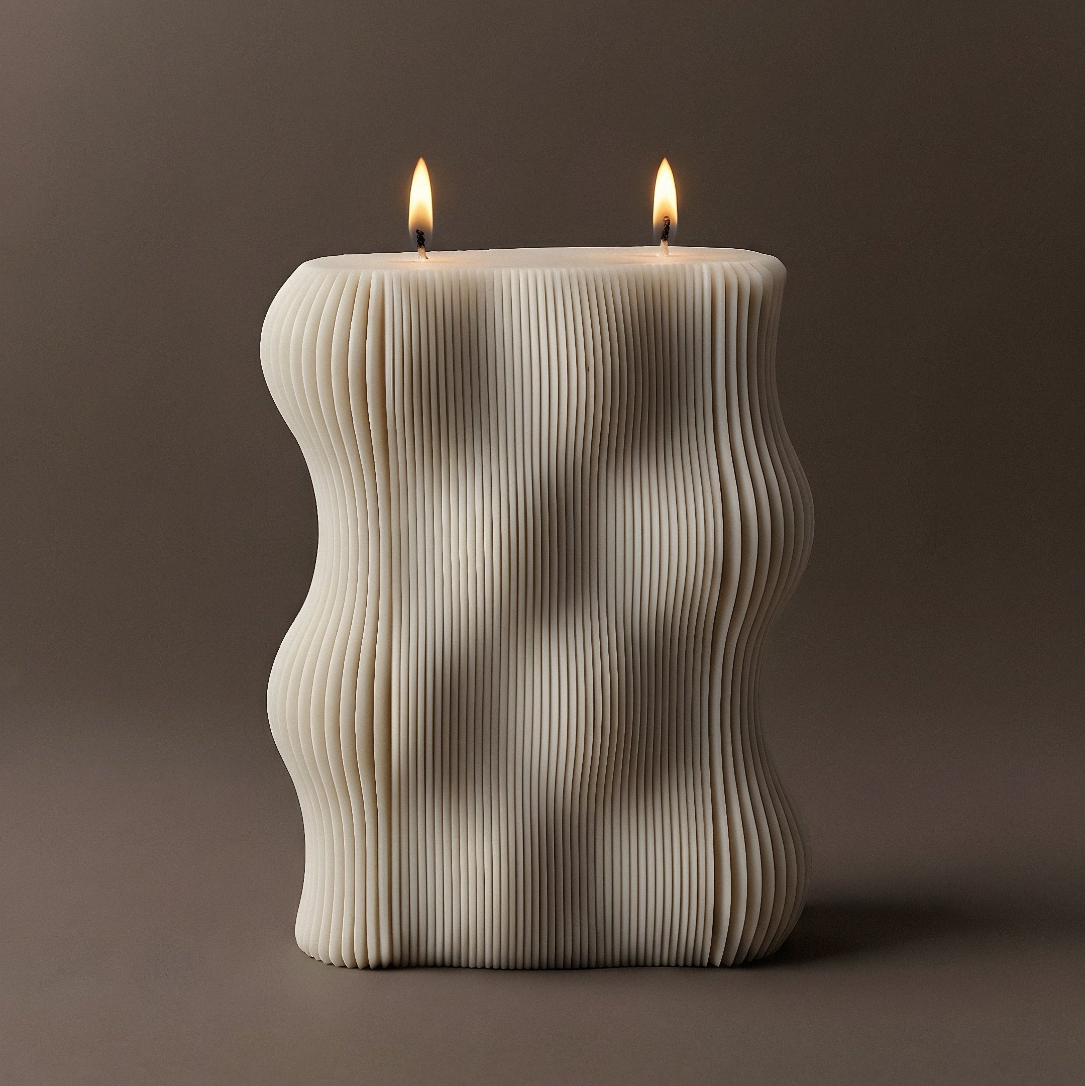 Ribbed sculptural soy wax pillar candle burning with two wicks — unscented handmade candle by LAWA Candles Los Angeles