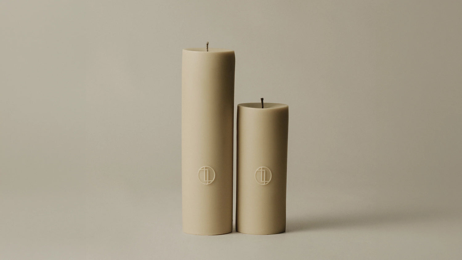 Lawa Set of 2 Pillar Beige candles on neutral background