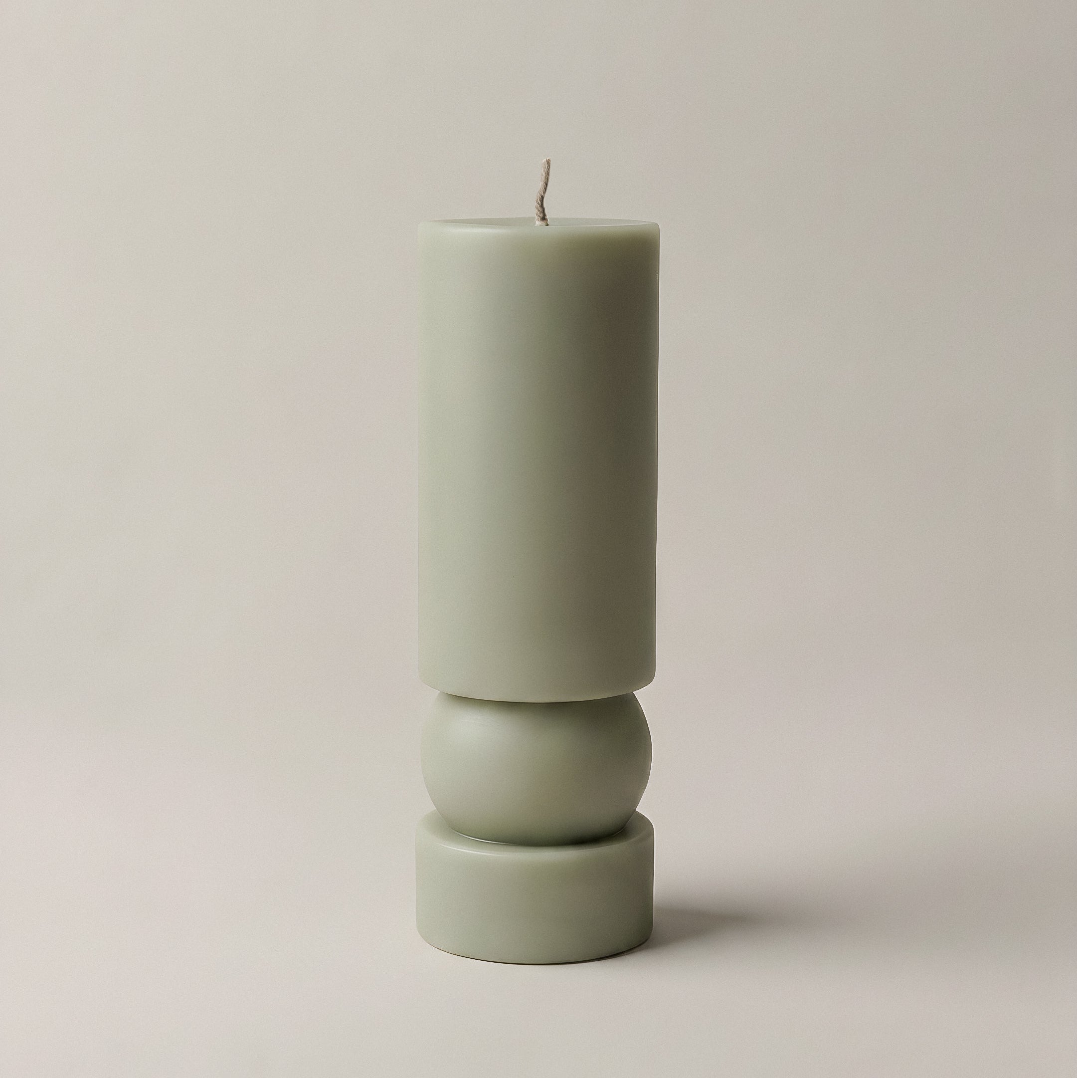 Close-up detail of handmade Zen sculptural candle showing smooth soy wax texture and cotton wick
