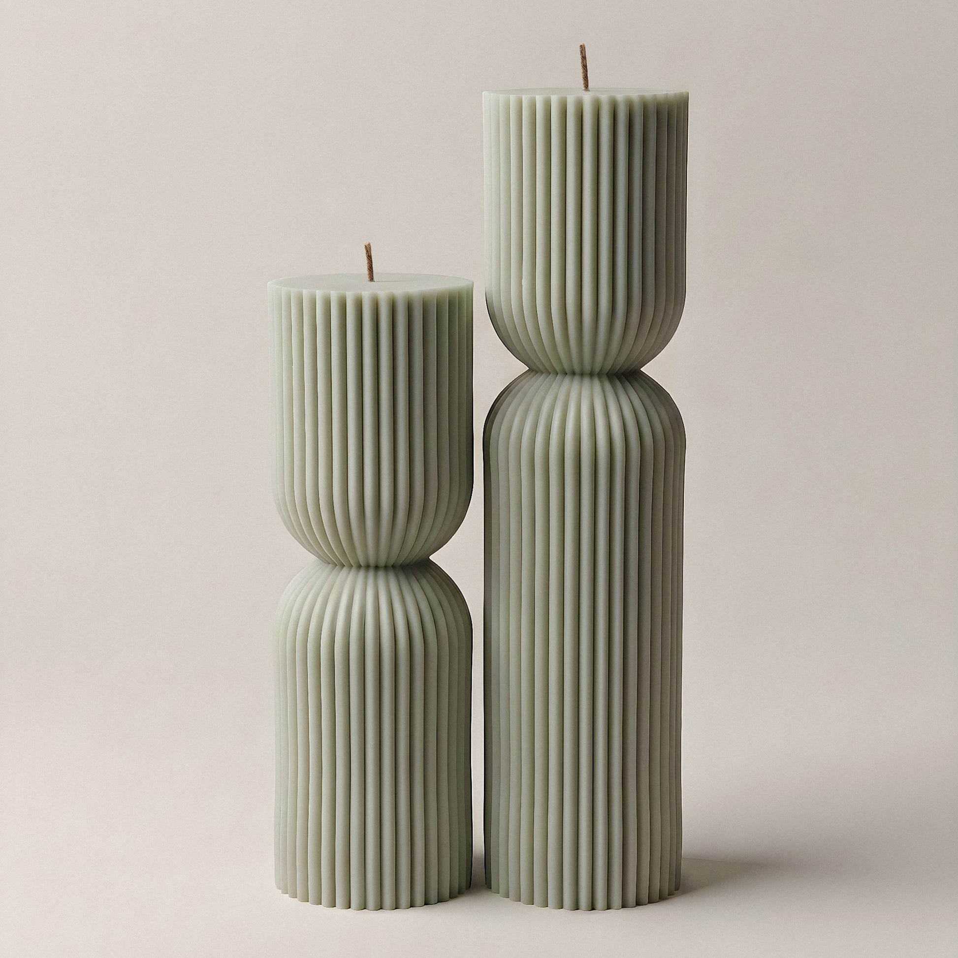 Close-up detail of handmade hourglass sculptural candle showing smooth soy wax texture and natural cotton wick