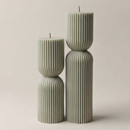 Close-up detail of handmade hourglass sculptural candle showing smooth soy wax texture and natural cotton wick