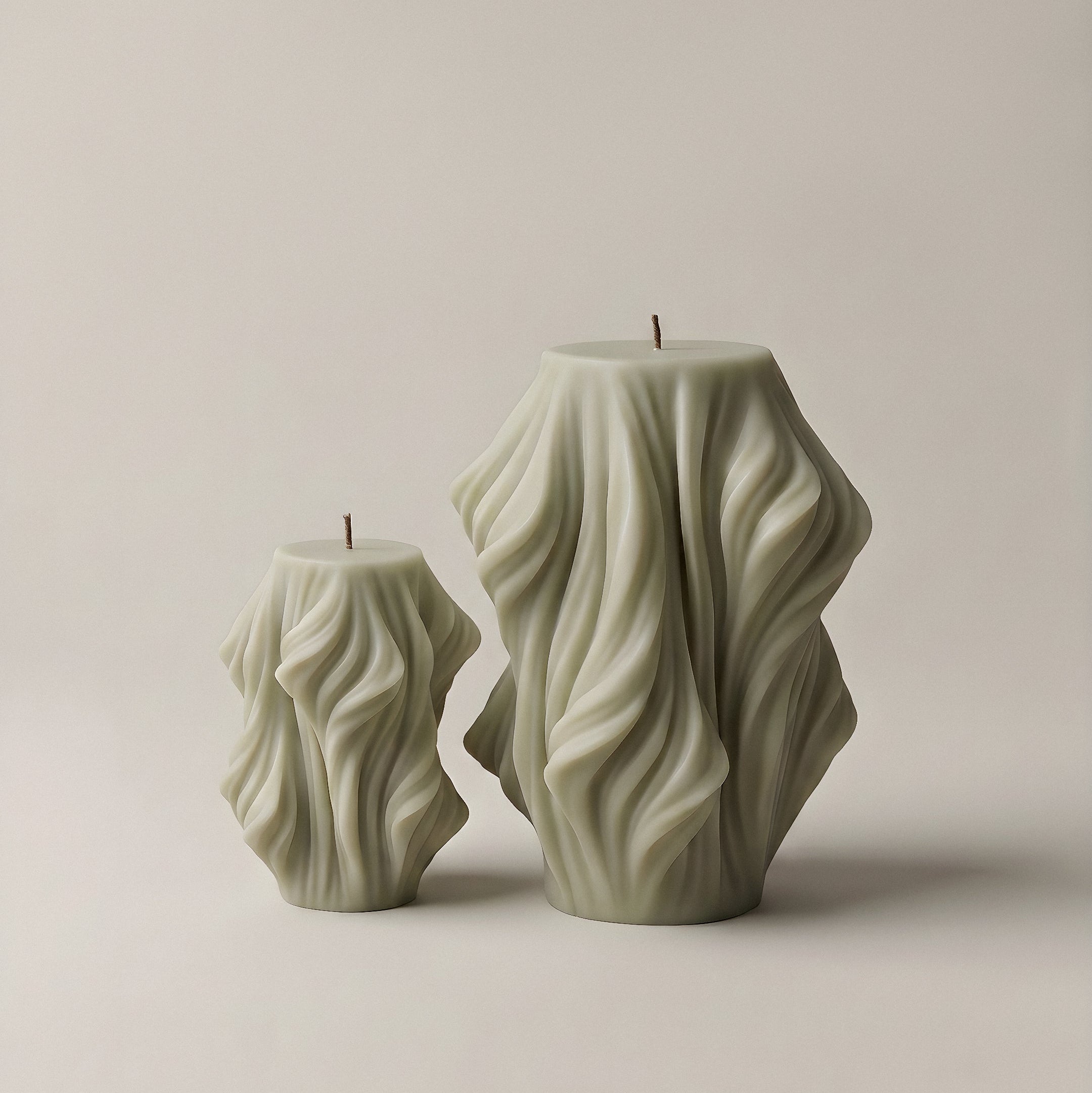 Handmade sculptural candle with cascading wave design in soy wax, unscented detail close-up shot