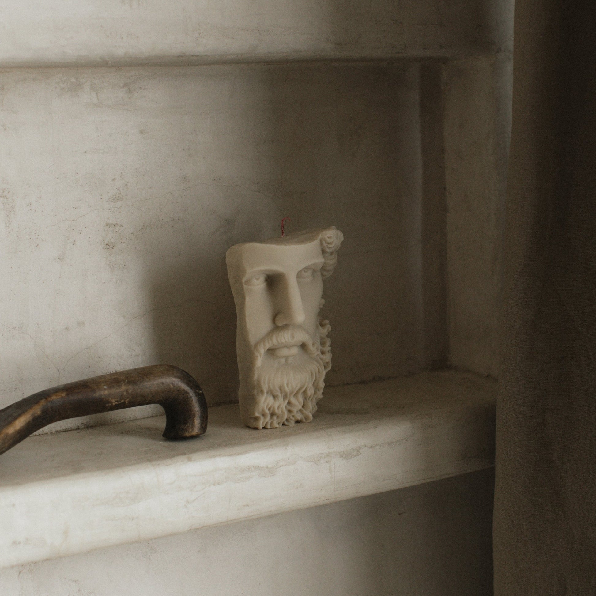 Greek face sculptural candle handmade from soy wax showing side profile detail against white background