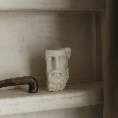 Close-up detail of handmade Greek face sculptural candle showing smooth soy wax texture and artistic features