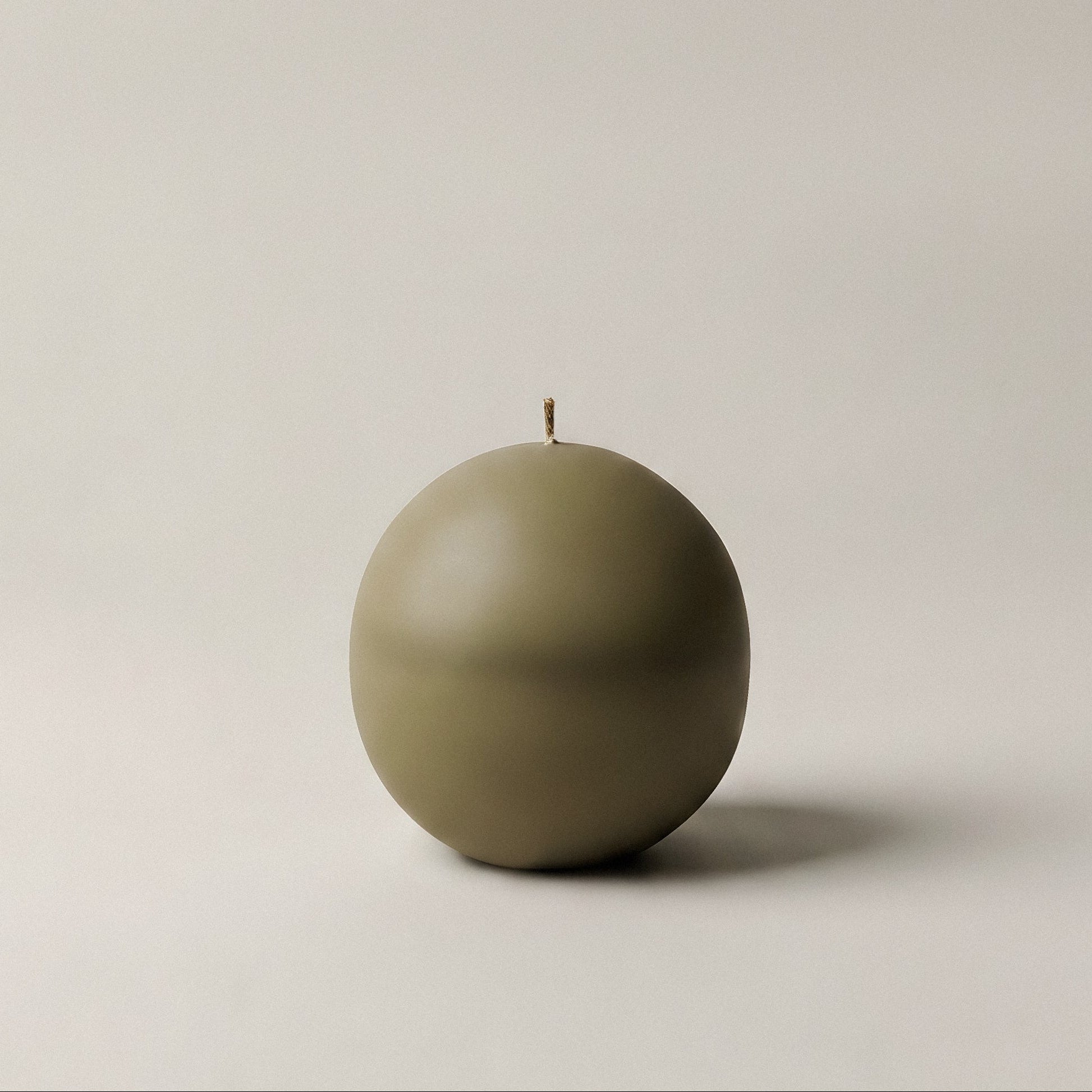 Close-up detail of handmade unscented sphere candle showing organic texture and premium soy wax finish