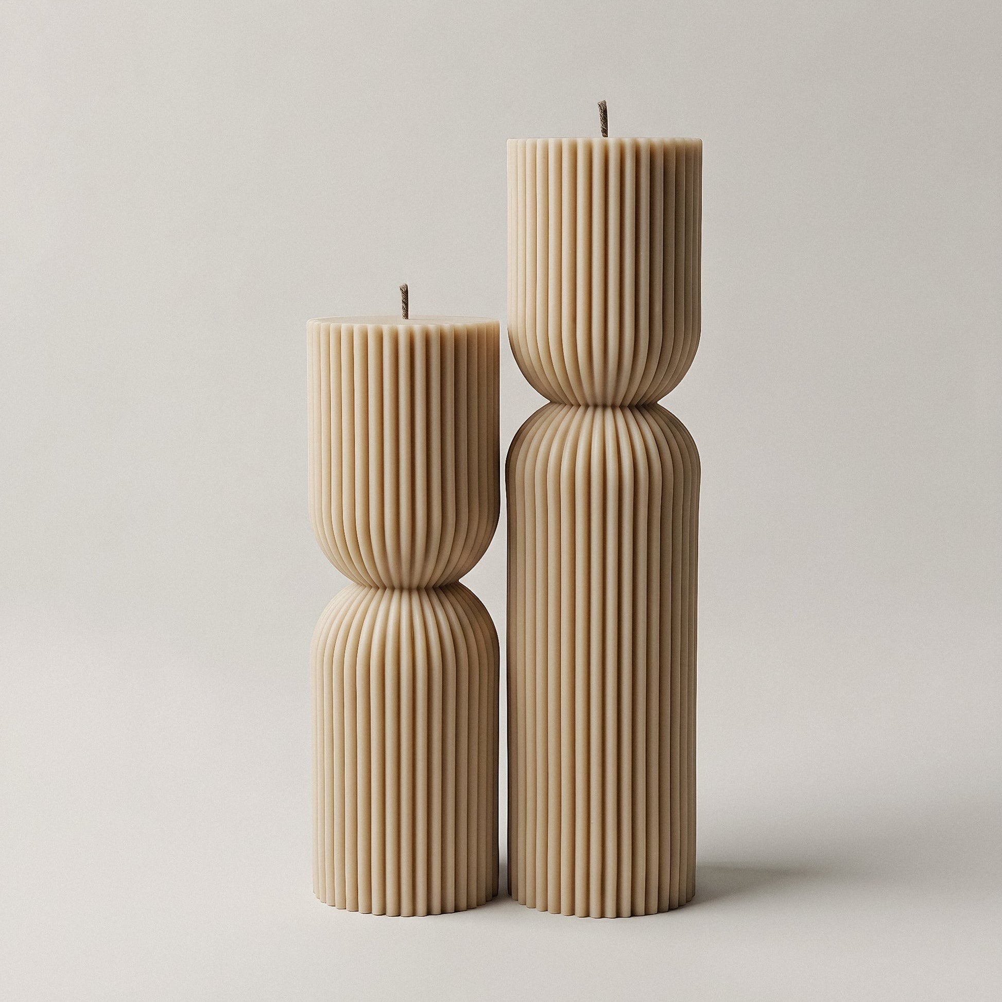Close-up detail of handmade hourglass sculptural candle showing smooth soy wax texture and curved silhouette