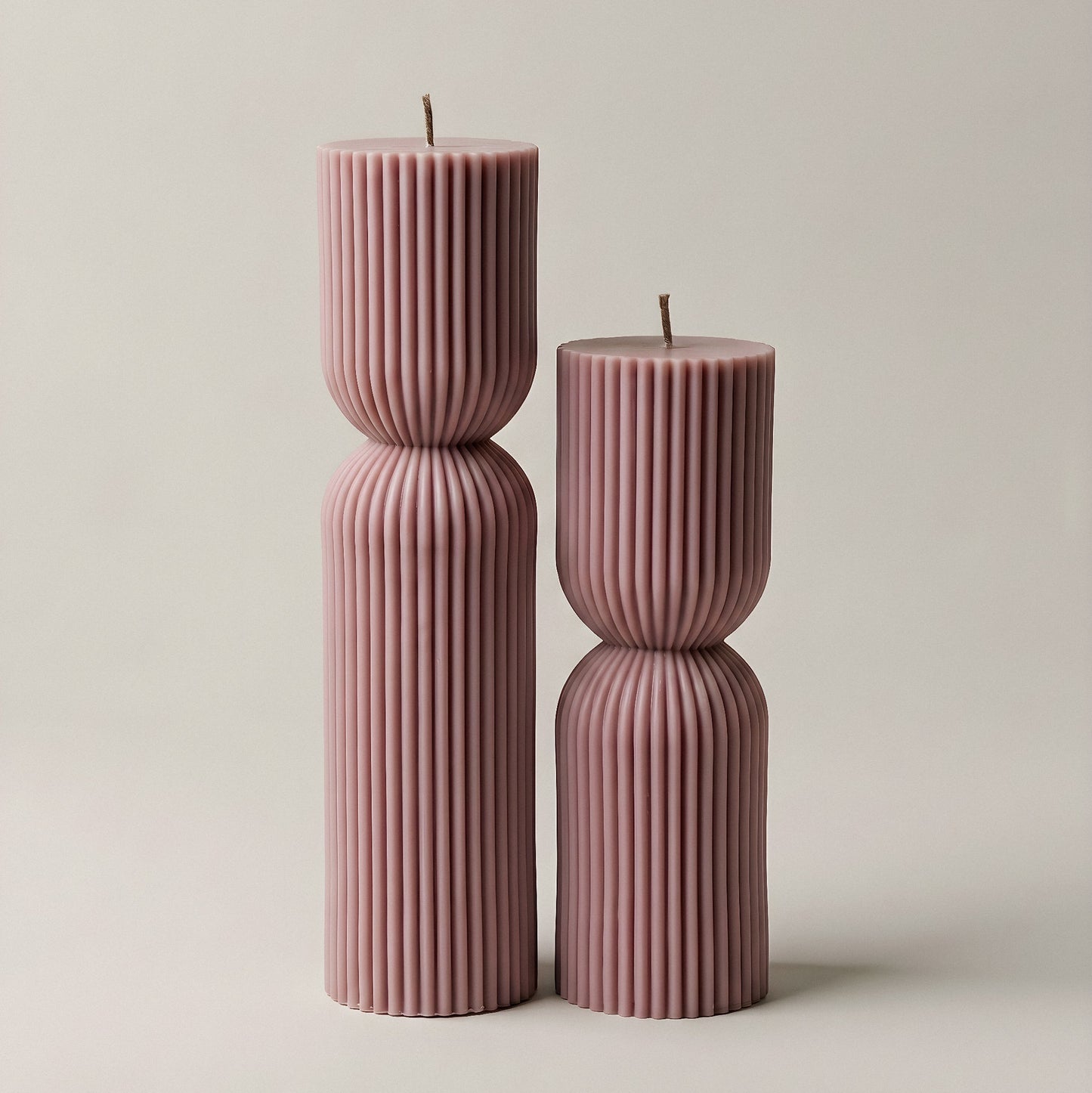 Close-up detail of handmade hourglass sculptural candle showing smooth soy wax texture and elegant curves