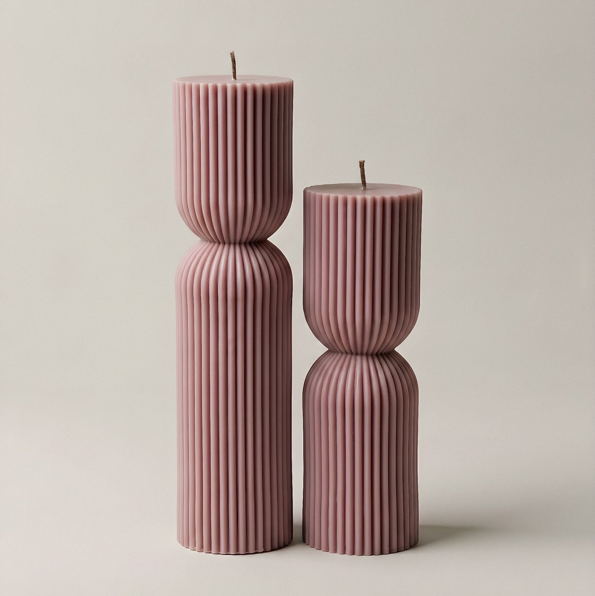 Close-up detail of handmade hourglass sculptural candle showing smooth soy wax texture and elegant curves