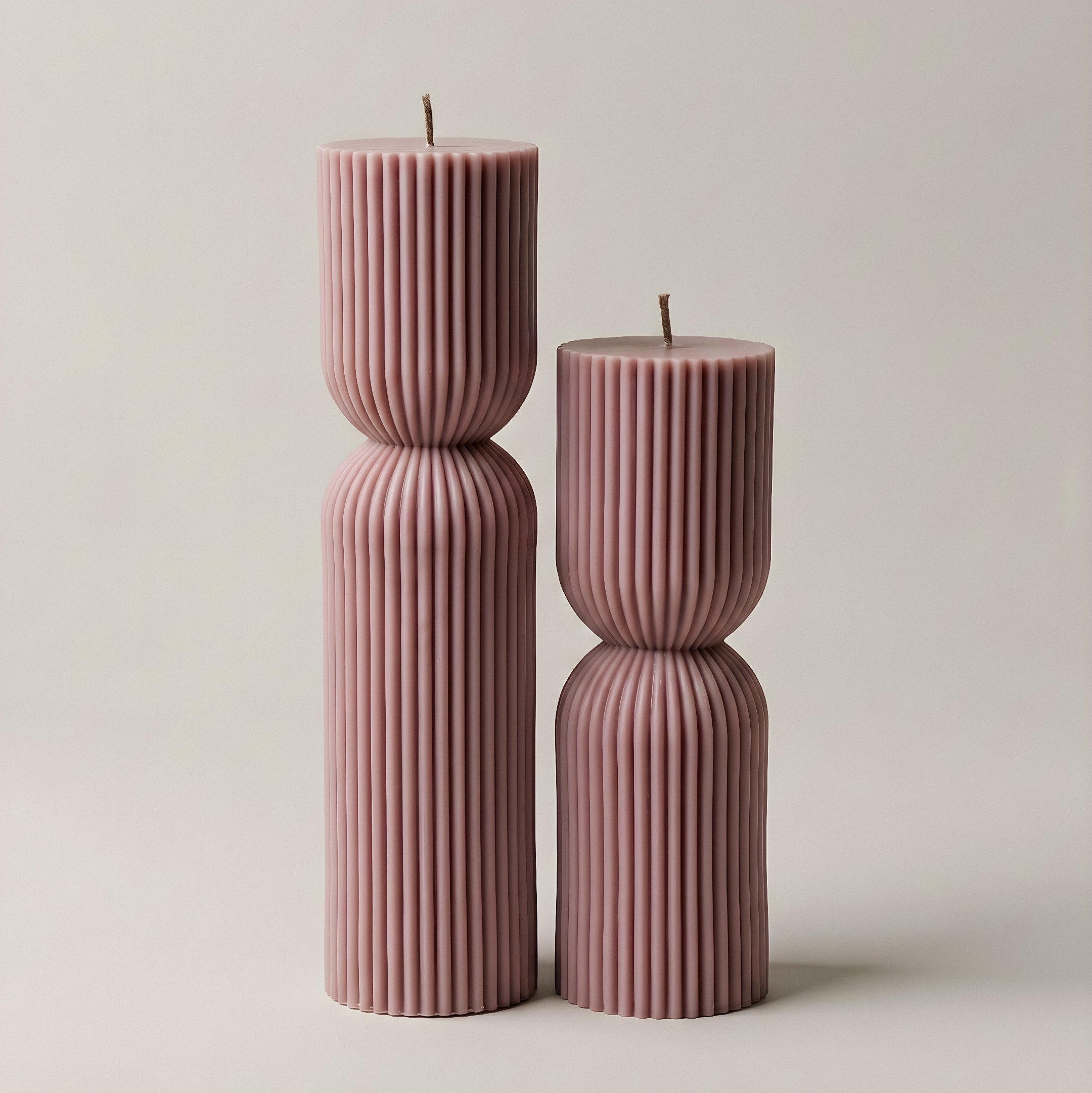 Close-up detail of handmade hourglass sculptural candle showing smooth soy wax texture and elegant curves