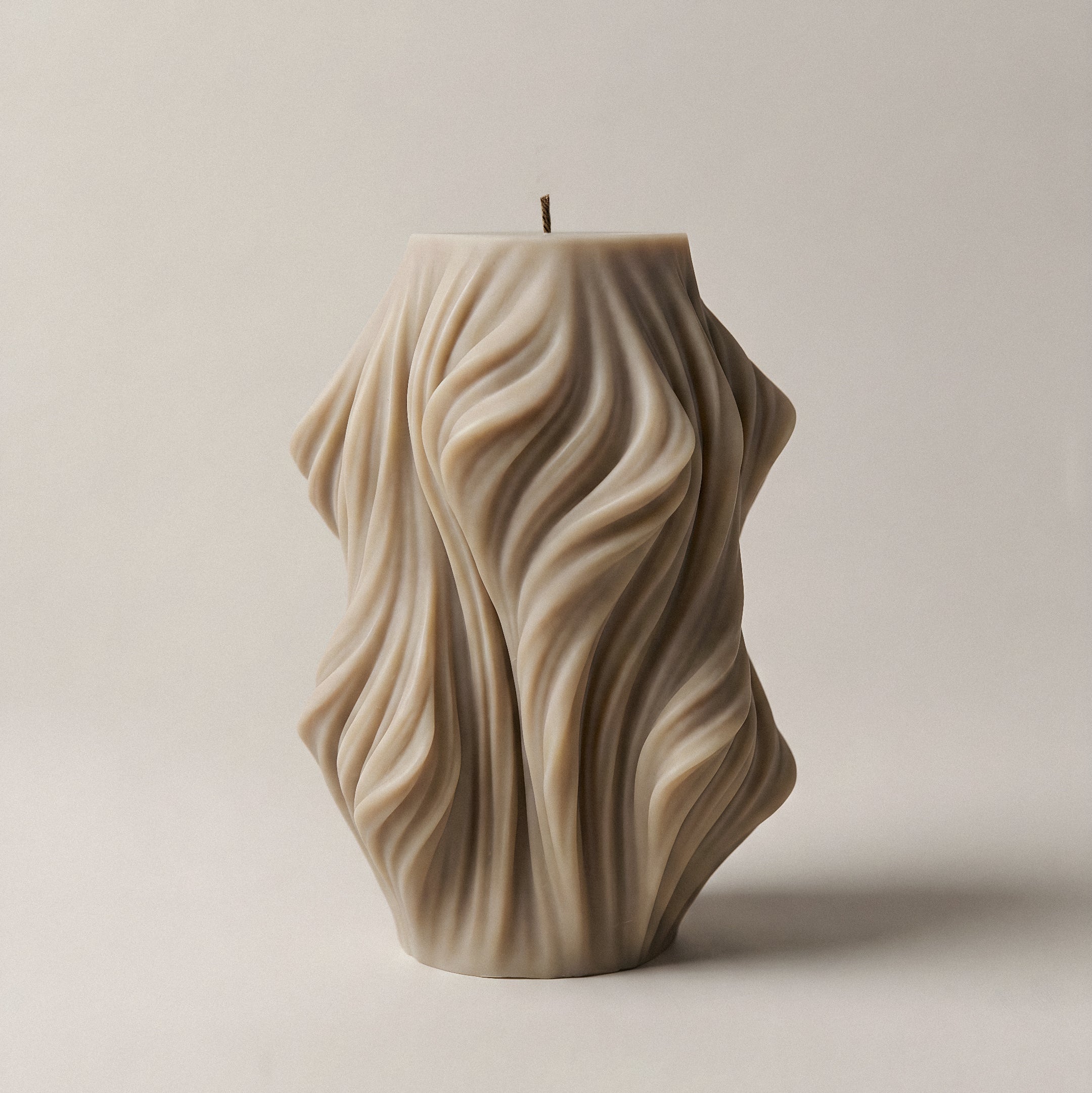 Close-up detail of handmade sculptural candle showing cascading wave texture in premium soy wax from Los Angeles