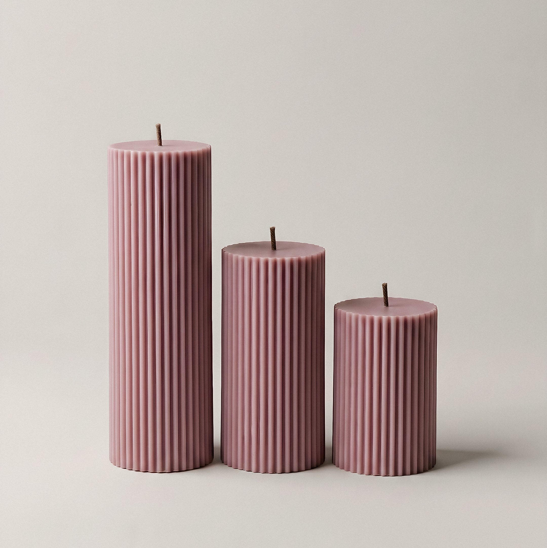 Close-up detail of handmade ribbed sculptural candle showing premium soy wax texture and vertical ridges