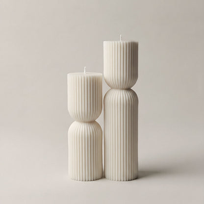 Close-up detail of handmade hourglass sculptural candle showing smooth soy wax texture and curves
