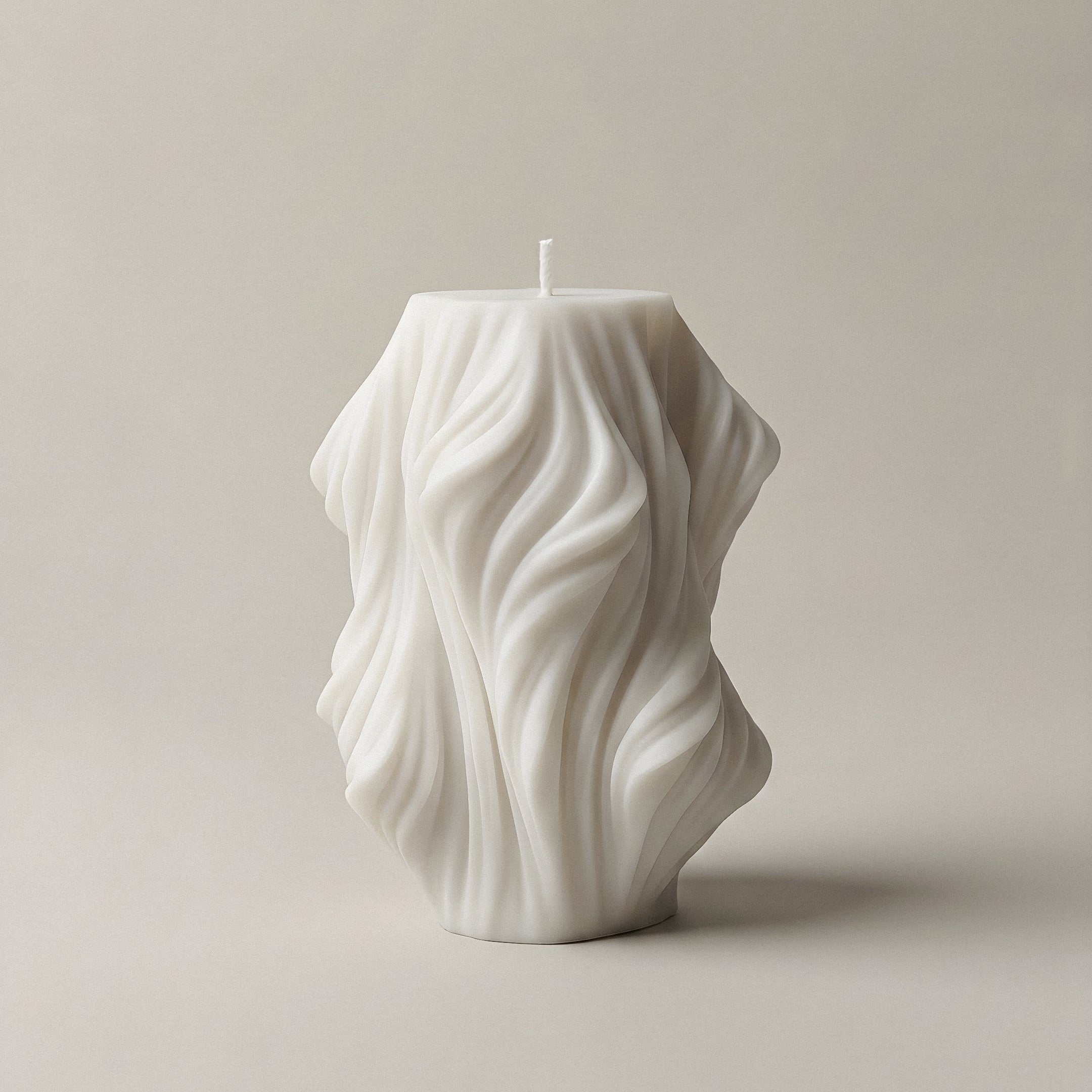 Close-up detail of handmade sculptural candle showing cascading wave texture in premium soy wax from Los Angeles