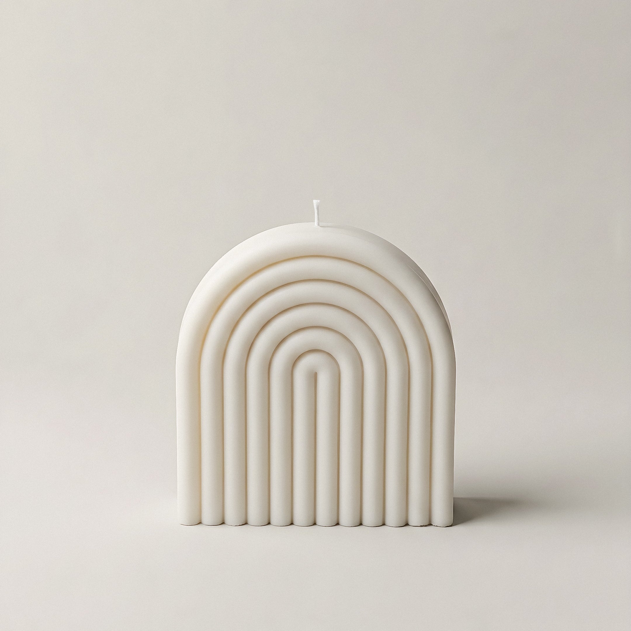 Close-up detail of handmade rainbow sculptural candle showing premium soy wax texture and vibrant color layers