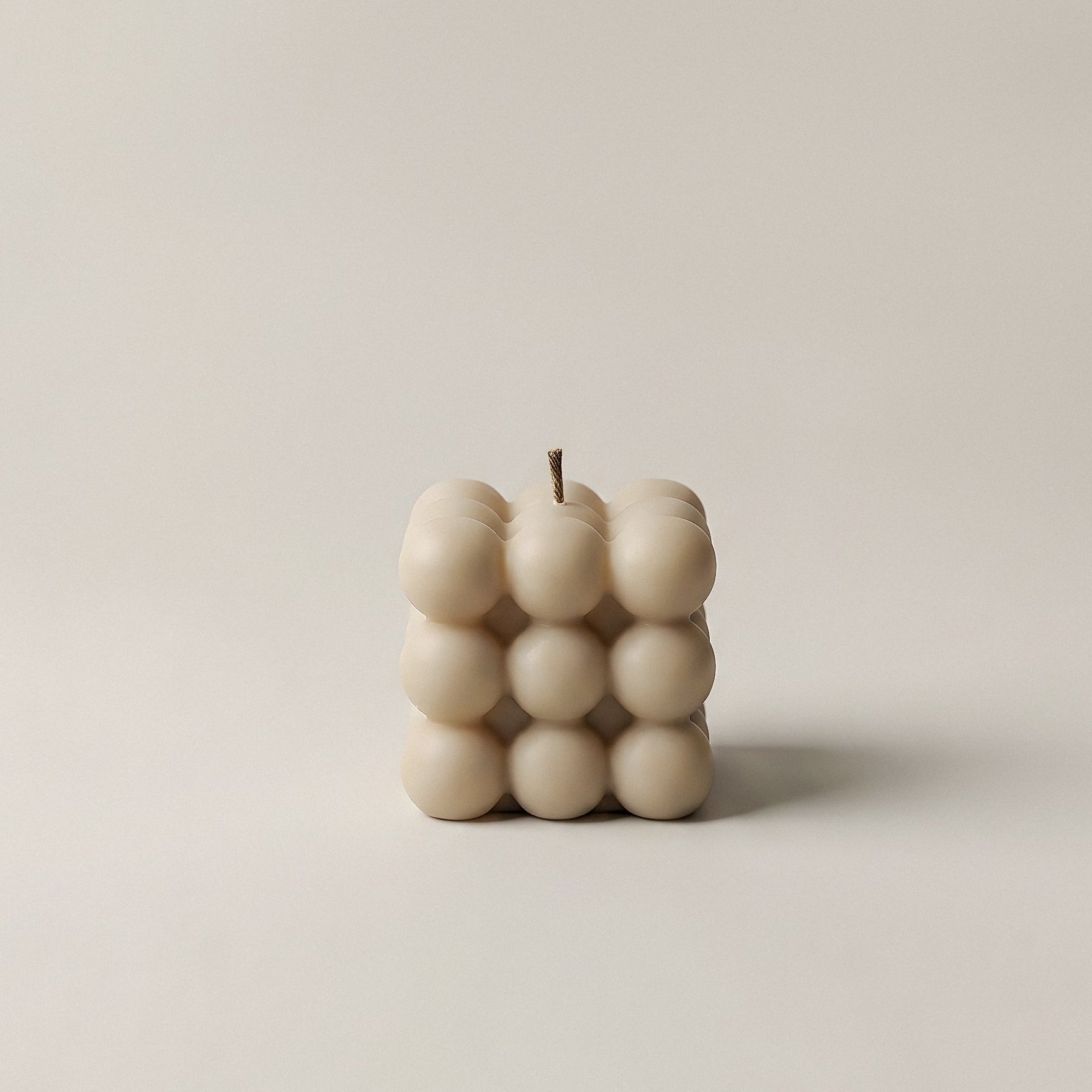 Close-up detail of handmade bubble sculptural candle showing organic textured surface and premium soy wax finish