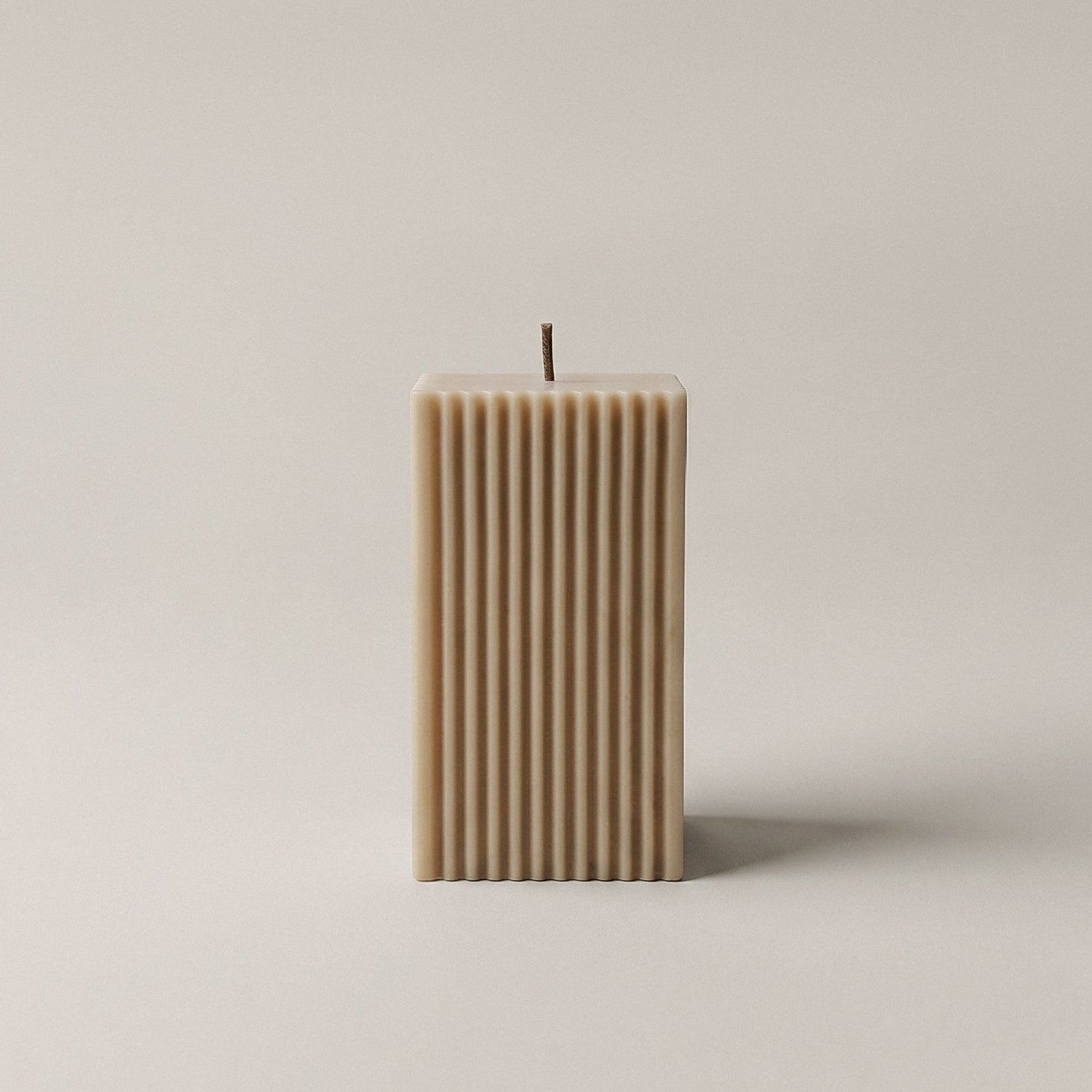 Close-up detail of handmade square ribbed sculptural candle showing premium soy wax texture and minimalist design