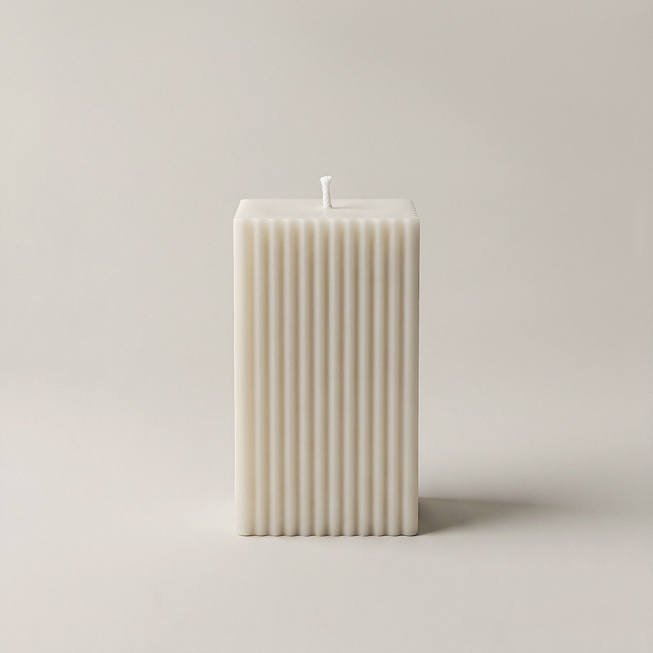 Close-up detail of handmade square ribbed sculptural candle showing textured ridges and premium soy wax finish