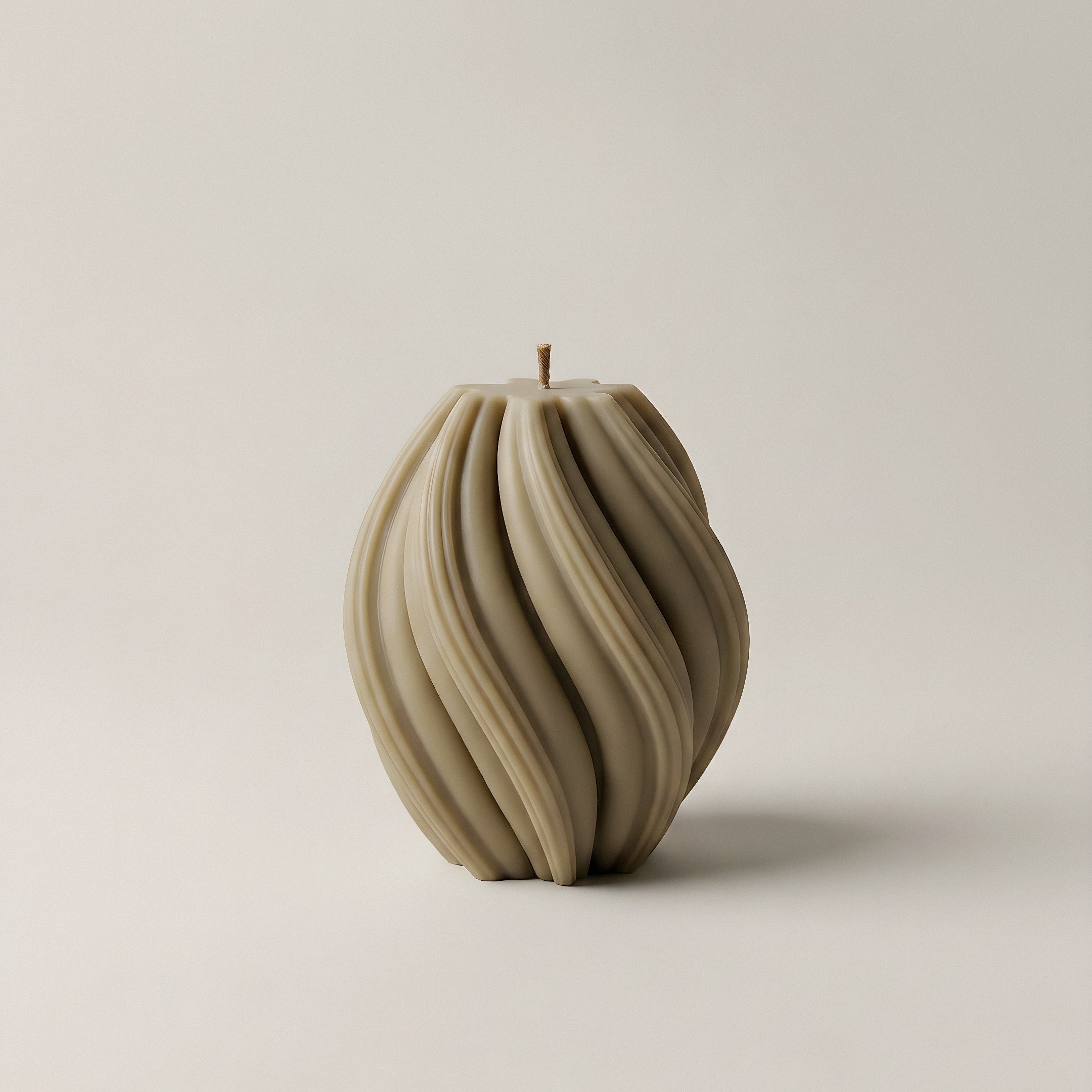 Handmade sculptural swirl candle detail showing premium soy wax texture and curves in natural light