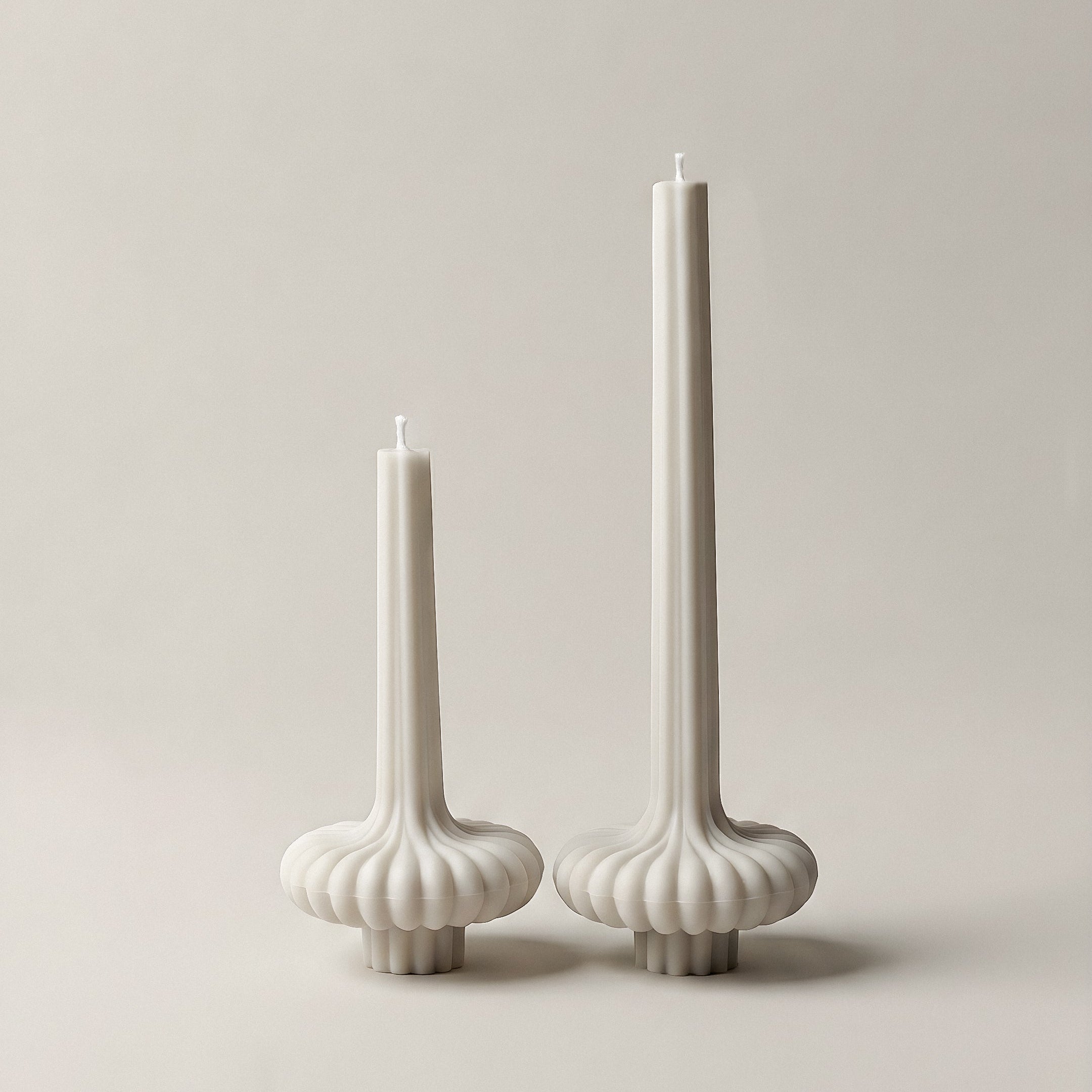 Close-up detail of handmade pumpkin sculptural candle showing smooth soy wax texture and organic curves