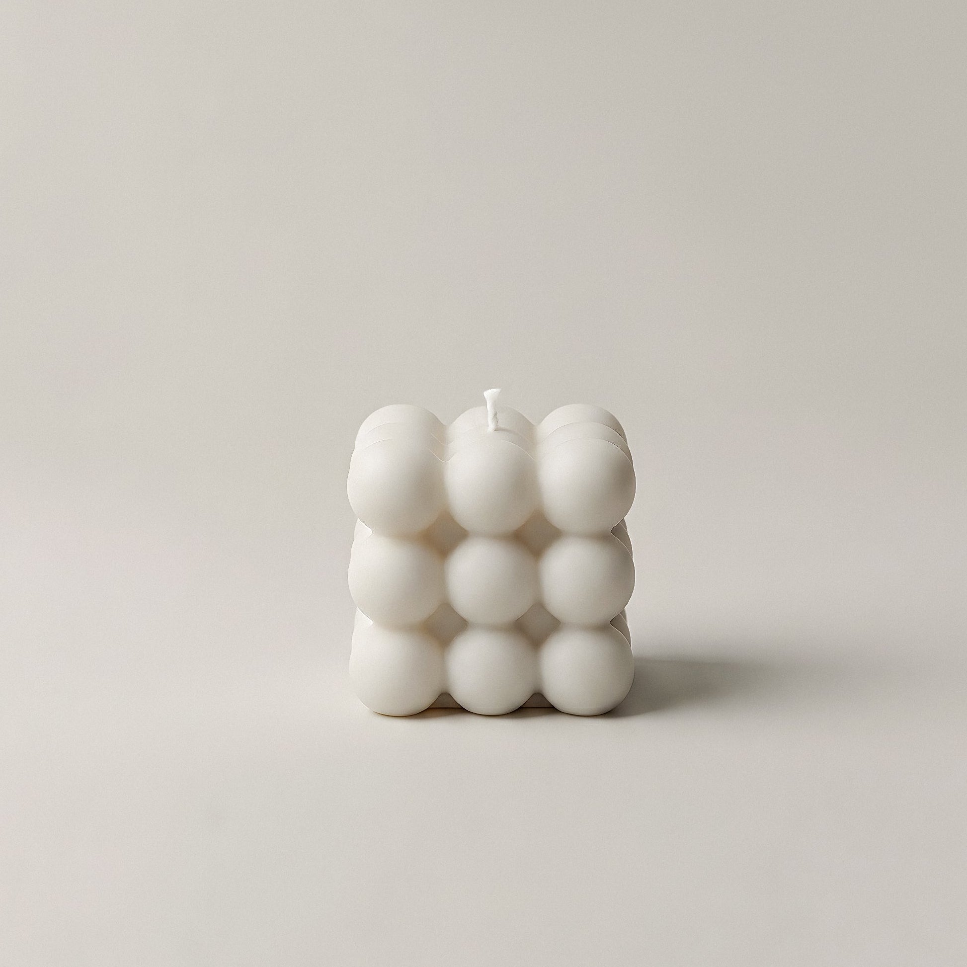 Close-up detail of handmade bubble sculptural candle showing textured soy wax surface and organic spherical form