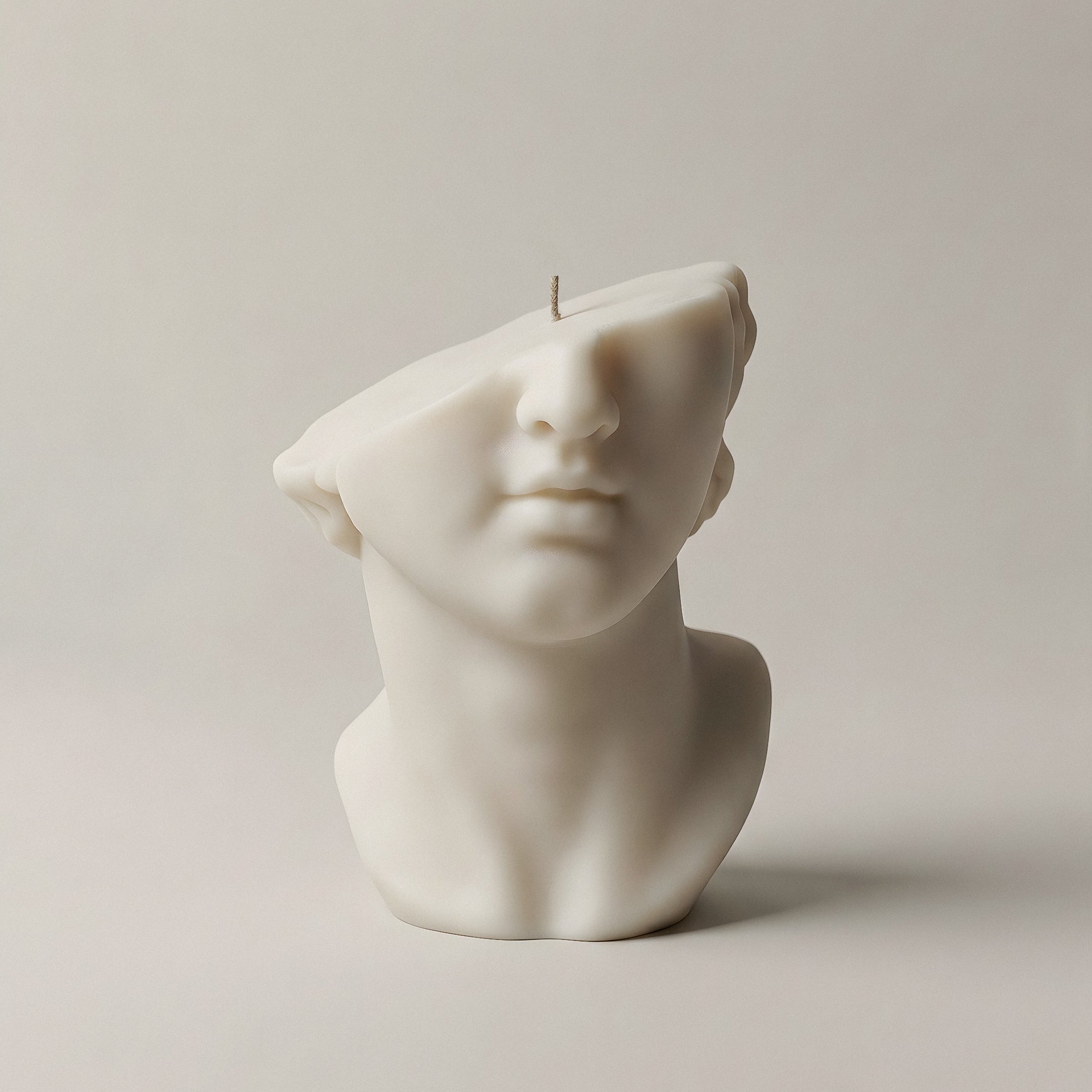 White Greek statue sculptural candle handmade from premium soy wax on neutral background